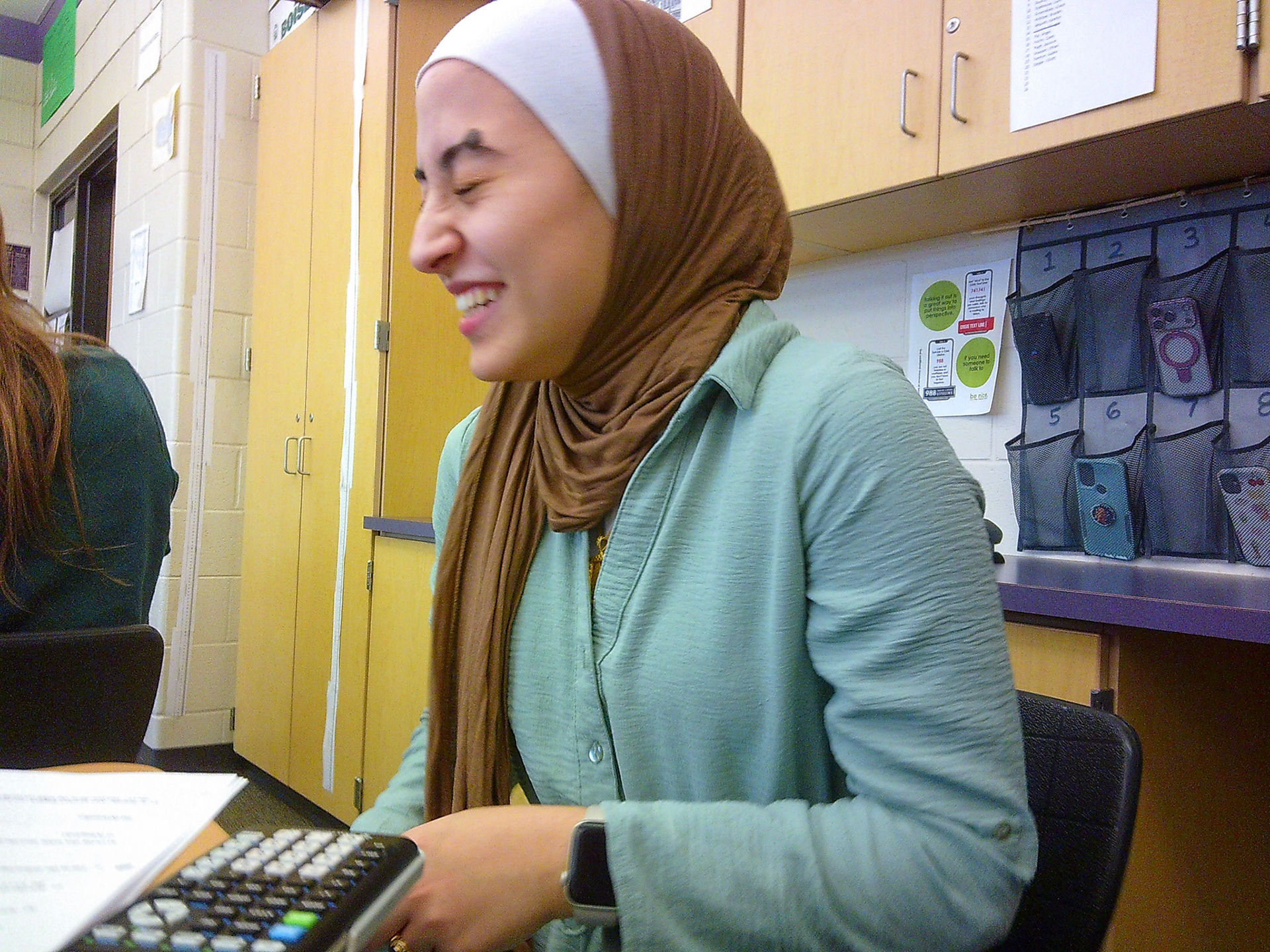 Senior Yasmeen Ghannam laughs to herself after cracking a joke in AP Stats. (Photo by Avarey Lippert)