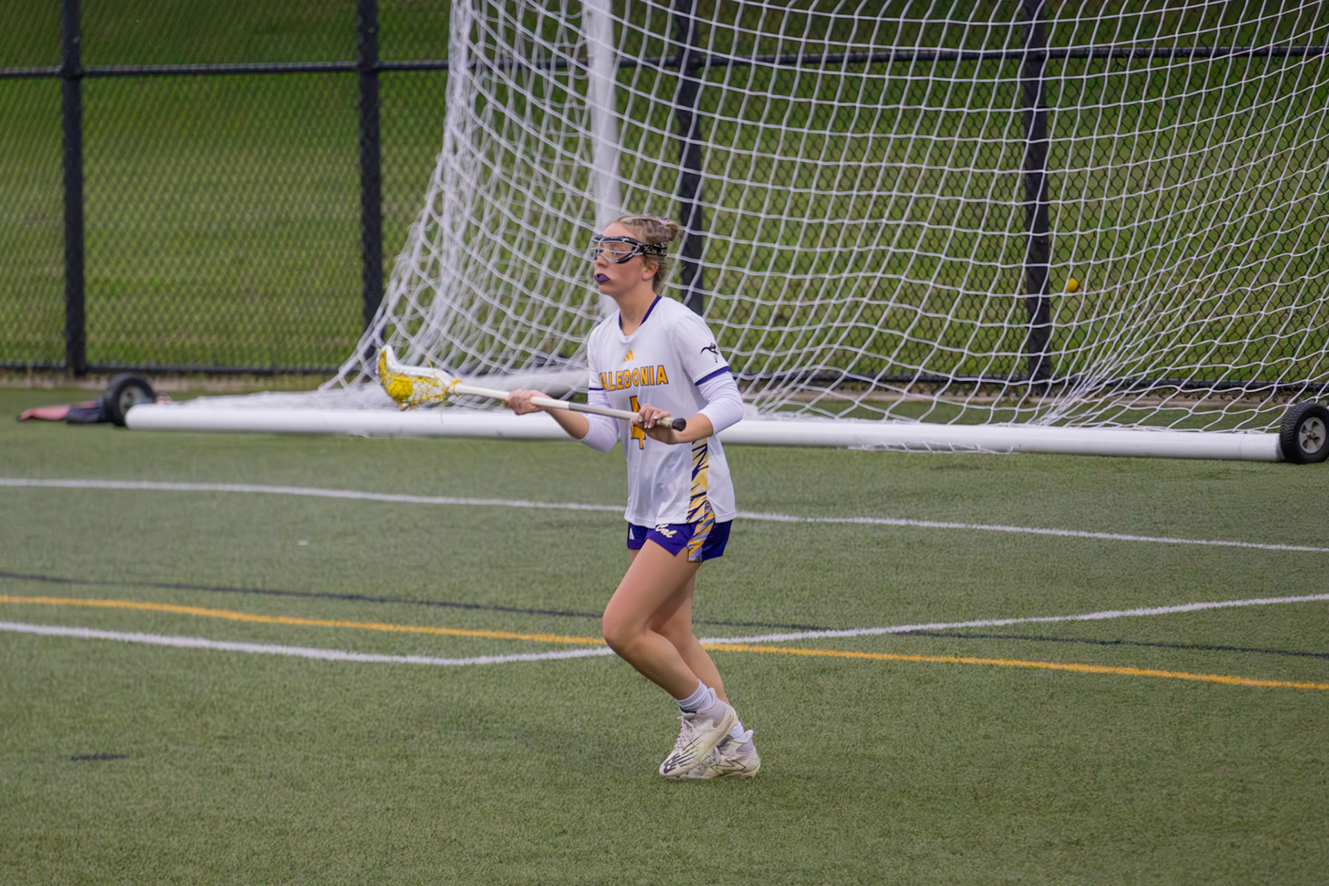 Caelyn Crocker scans the field, planning her next move as she carries the ball through midfield. (Photo by Abby Skibinski)