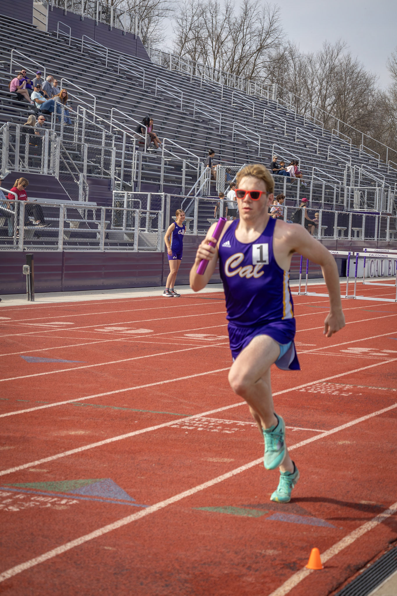 As the final leg of 4x800m relay, Andrew Barnum covers distance against Muskgeon. (Photo by Adi Malvankar)