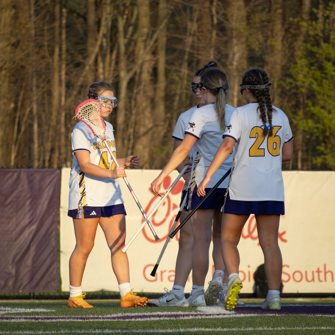 Teammates celebrate a goal with a stick tap. (Photo by Ellie VanderRoest)