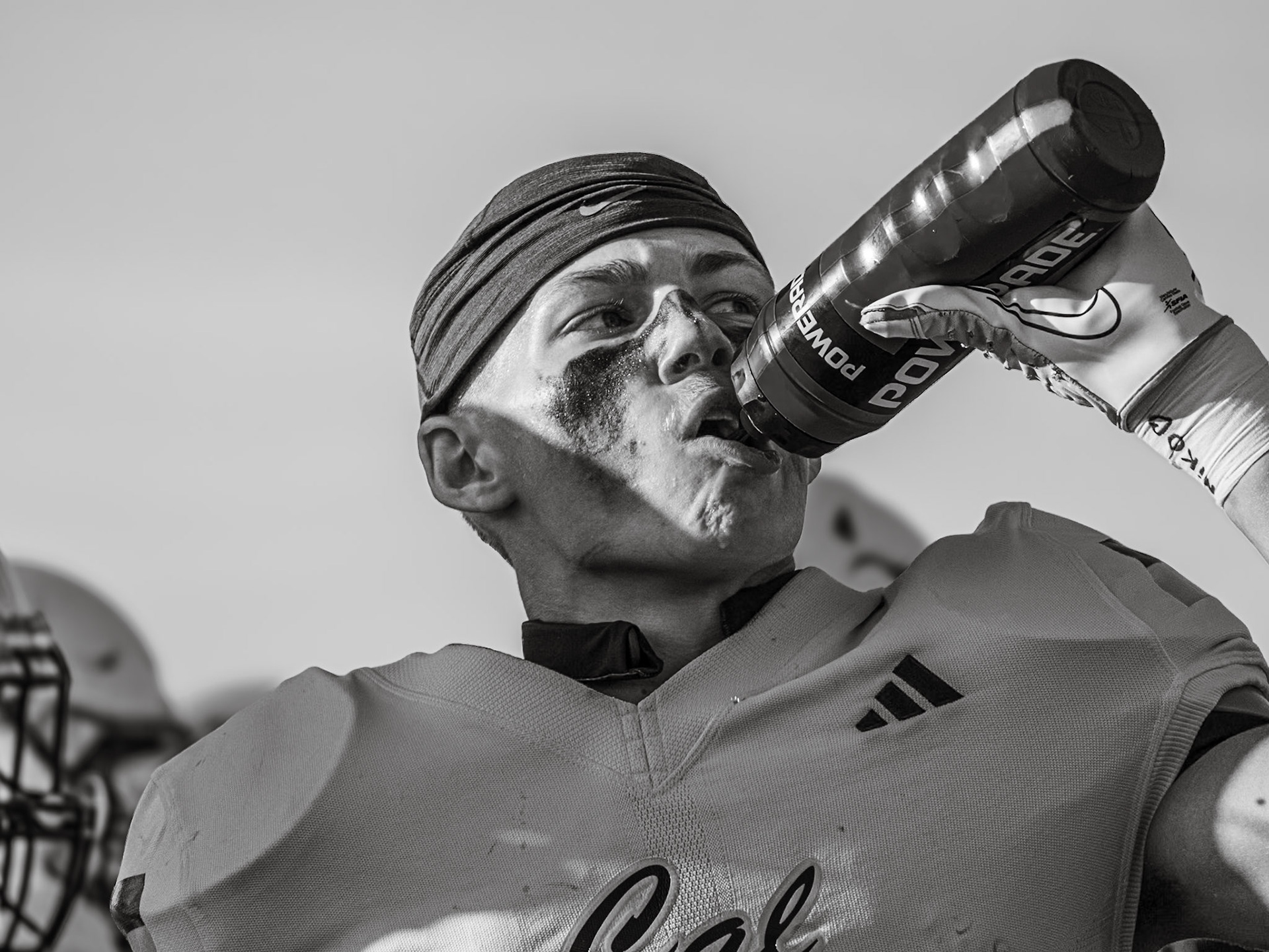 IN THE ZONE Mid-game against Hudsonville, Ben Geerdes cools off with a quick water break on a hot afternon (Photo by Lillian Jackson)