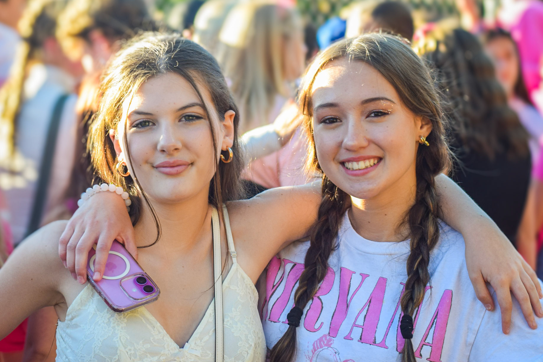 Sophmore Ava Deglopper and Freshman Harlow Robles have a good time in the make-shift student section during the final phase of construction on the new stadium. (Photo by Ollie Fox)