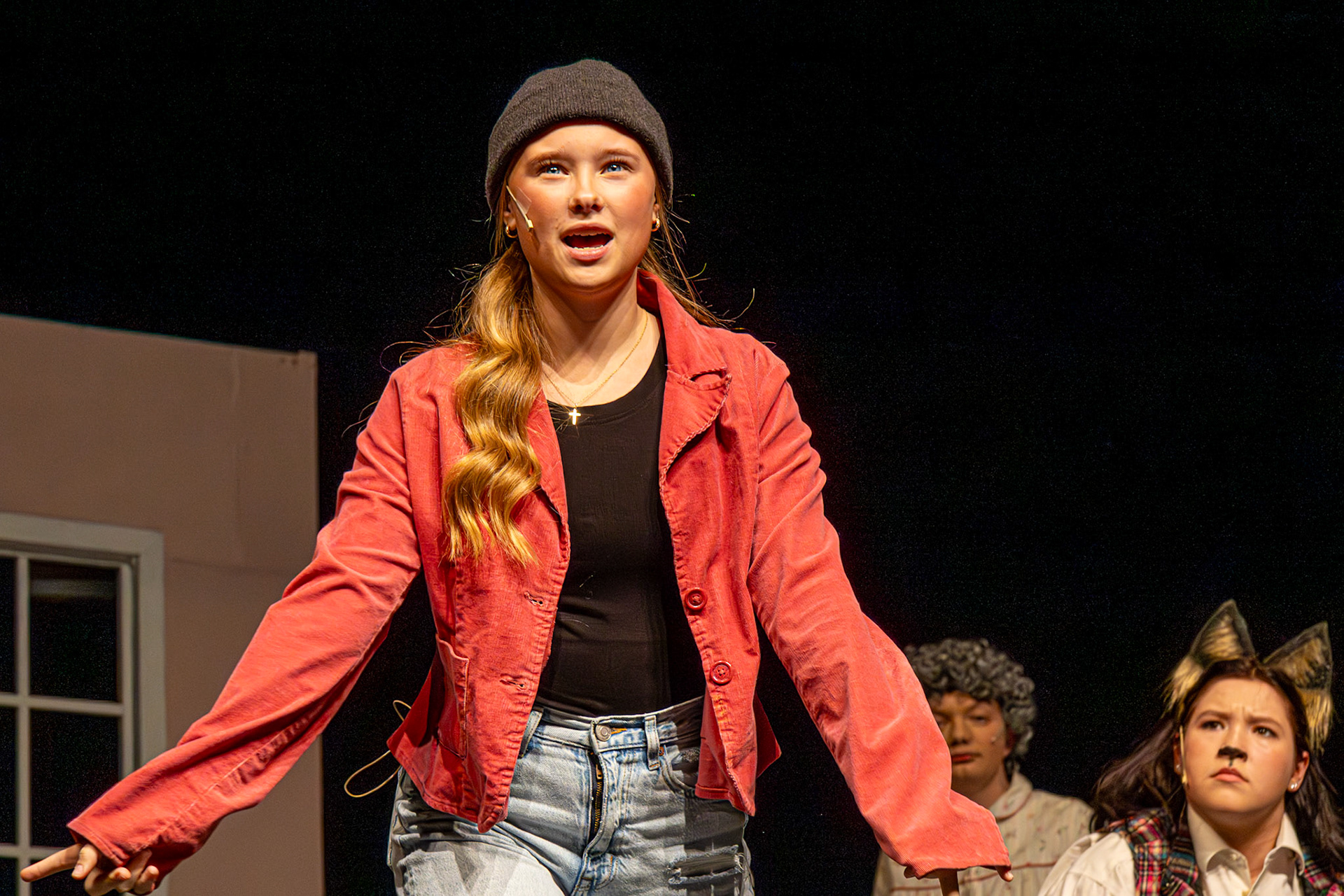 Alexis Visel displays resilience in her role as Little Red, alongside her castmates Kendall Somerville as The Wolf and Justin Brown as the Grandmother.