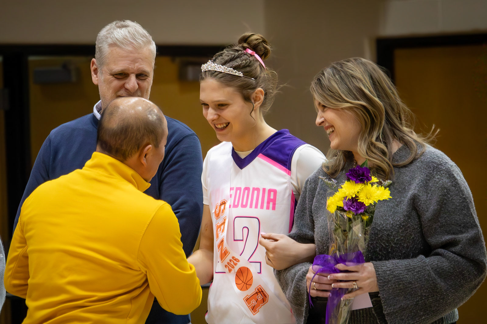 Athletic Director Phil Miedema shakes senior Jolie King’s hand at senior night. (Photo by Maggie Loomis)