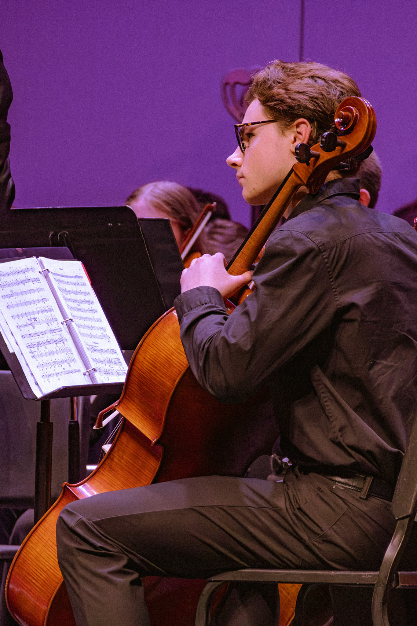 Senior Ethan Snapper watches the conductor during the orchestra concert.(Photo by Ollie Fox)