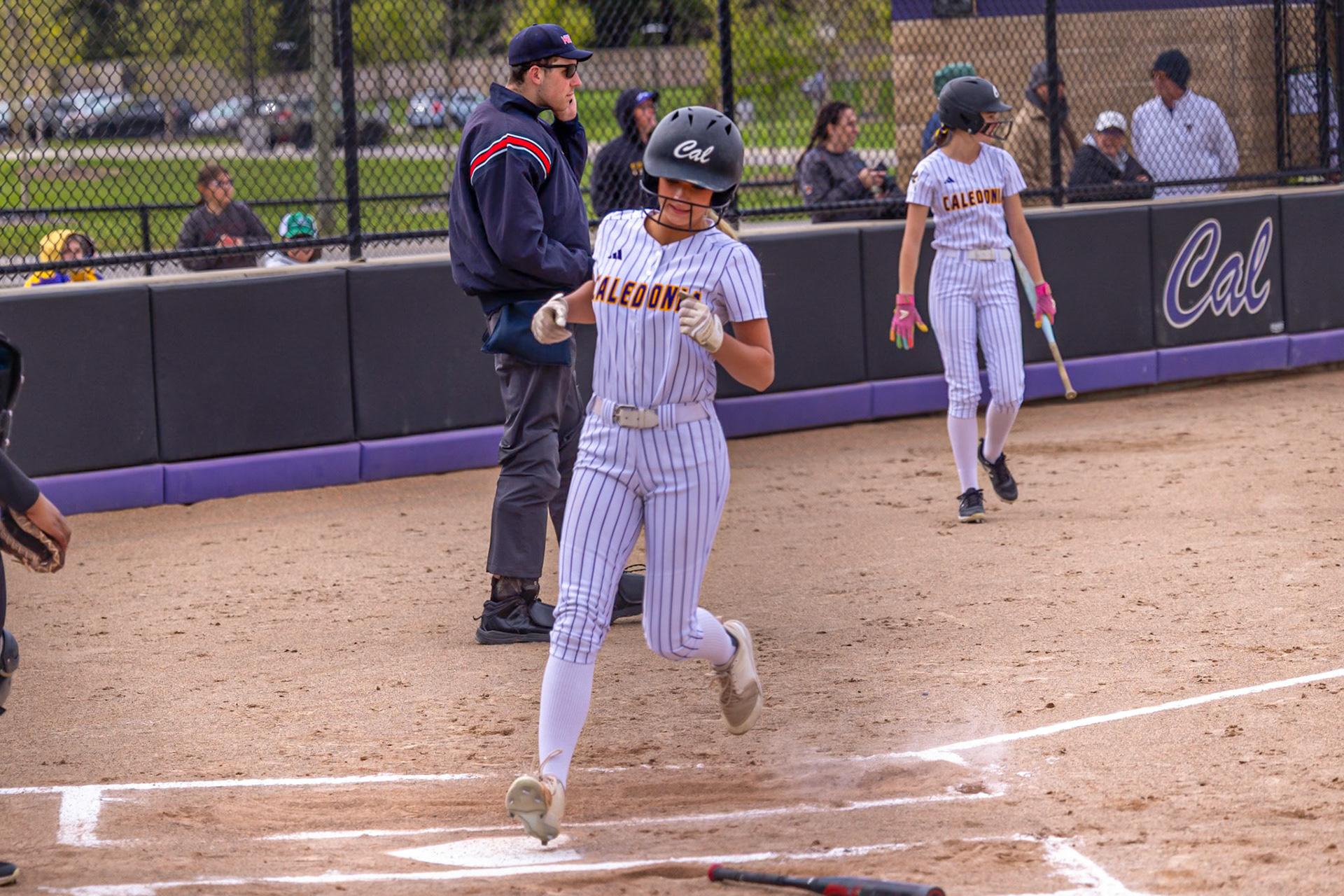 Brooke Haynes crosses the plate as the Scots add another run to the scoreboard in the win vs Muskegon. (Photo By Landry Mueller)