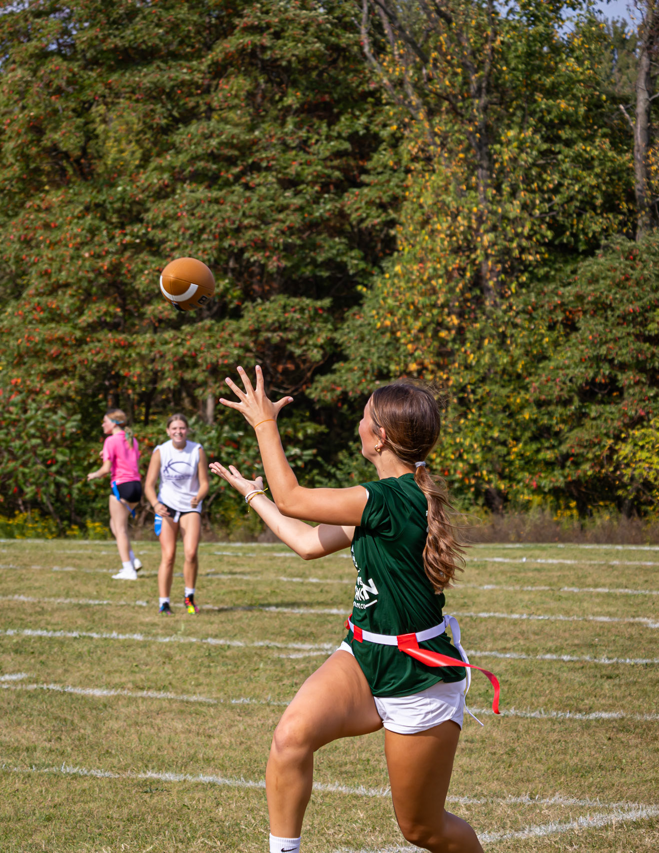 LONG DRIVE! Baylee DeVries sprints in for the catch, thinking about nothing but game day. (Photo by Jaren King)