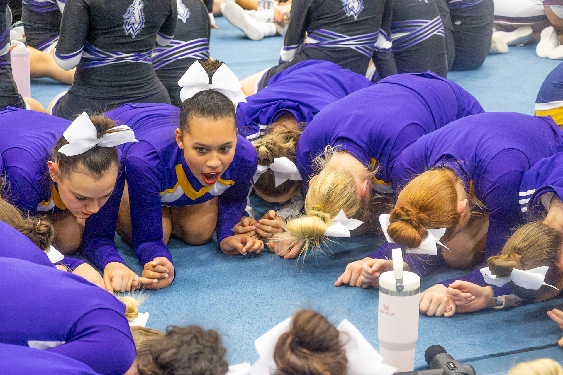 Hand in hand, the team waits together, stunned and overjoyed as they realized they earned their highest score of the season.(Photo by Lilli Jackson)