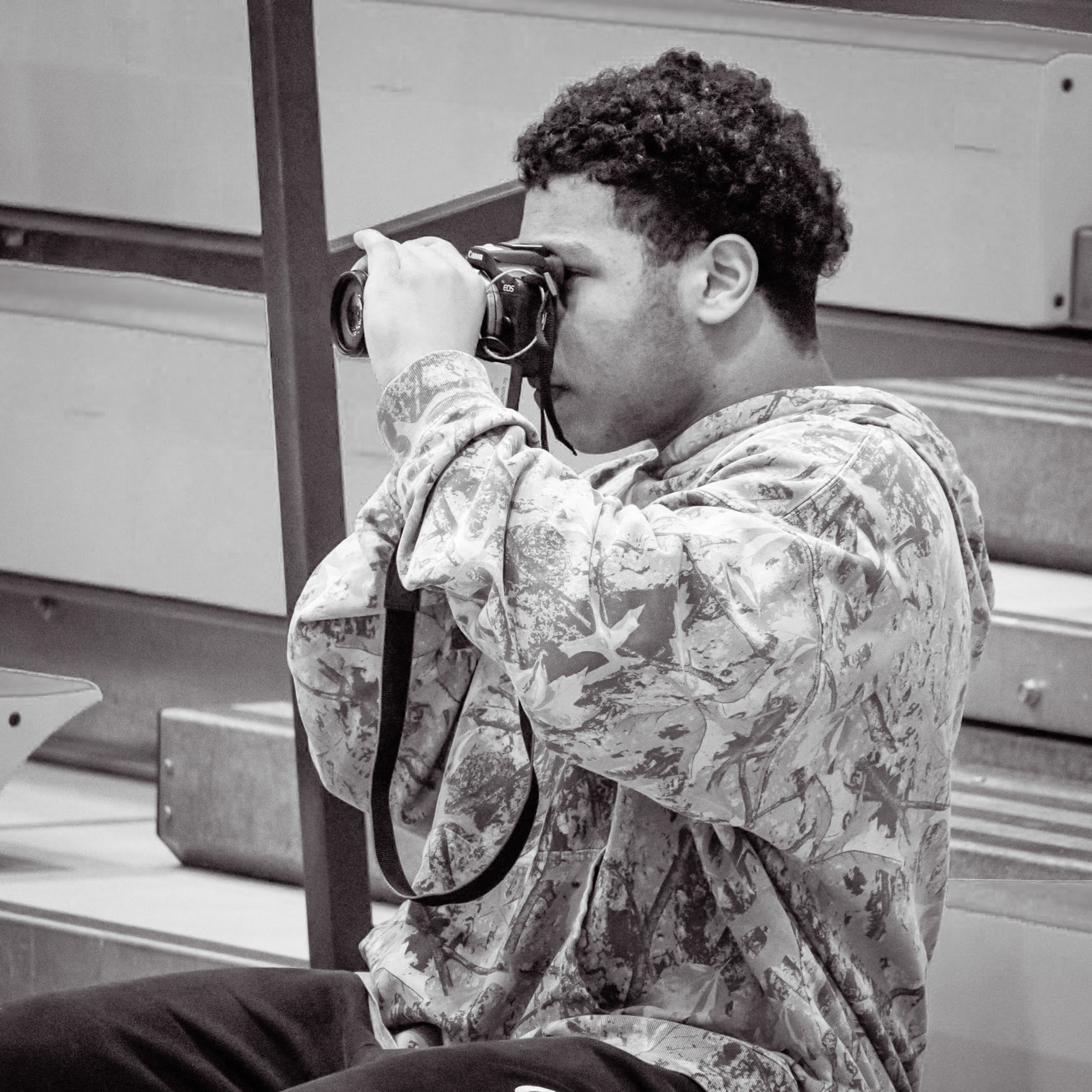 COURT COVERAGE Joseph Dunn photographs the girls varsity basketball team against Muskegon. (Photo by Natalia Teneyuque)