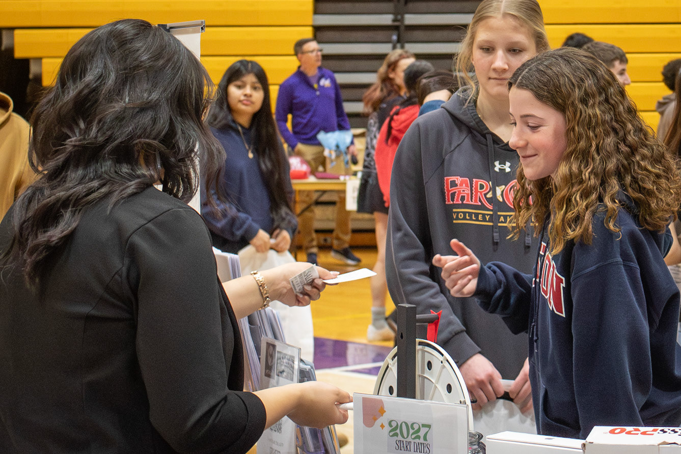 Chloe Klapmust earns a prize card while learning about cosmetology opportunities at the college fair. (Photo by Mya VanderZwaag)