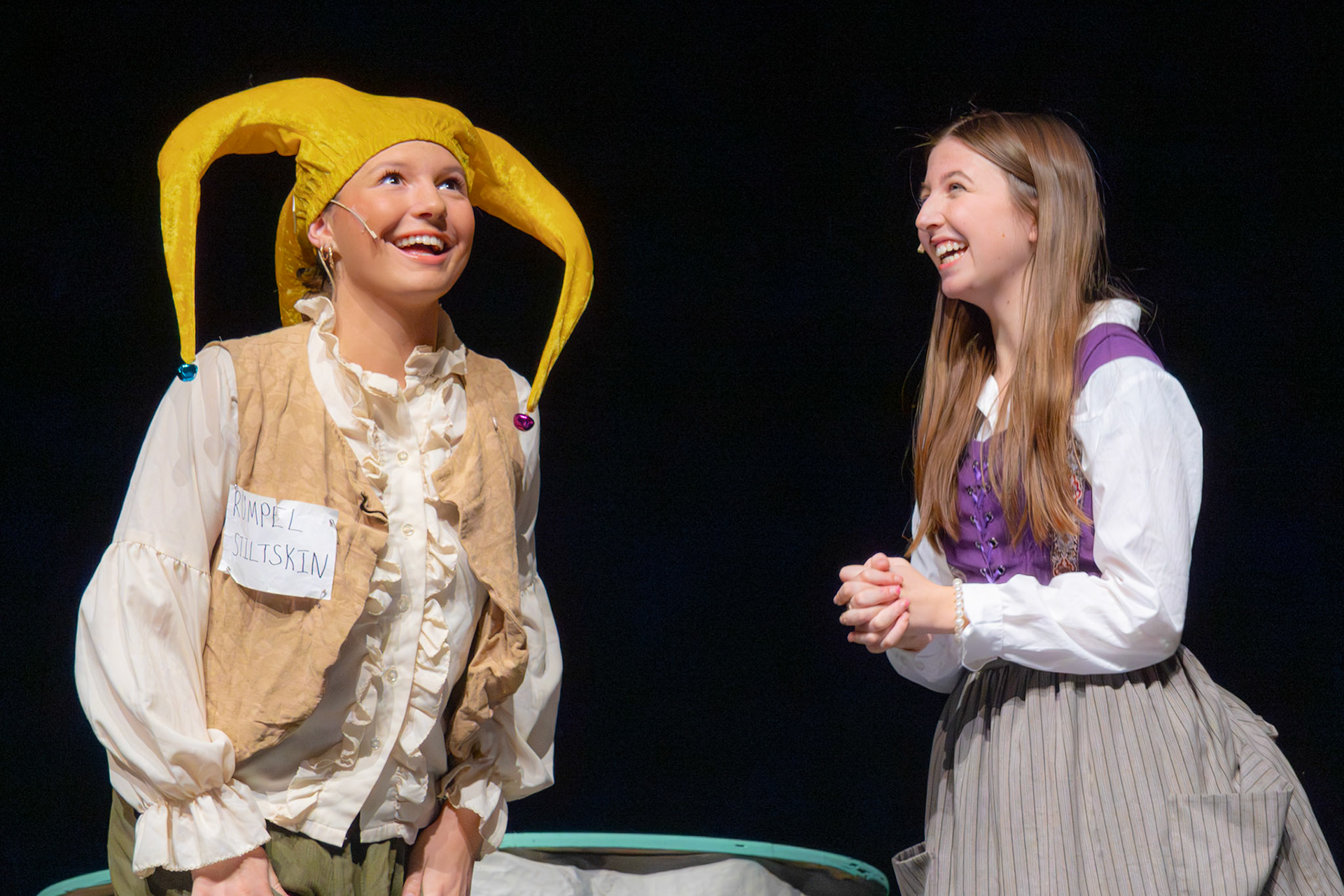 As Stella Barnwell and Mya-Rose Slosser are making "The Brothers Grimm Spectaculathon" play come alive with their humerous and magical acting,  their characters meet for the first time to potentially exchange a life-changing deal. (Photo by Caralyn Price)