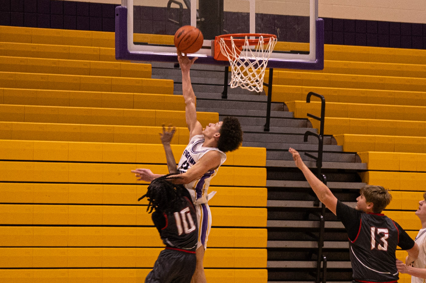 Levell Dunn goes up strong for another dunk attempt, attacking the rim with determination and energy. (Photo by Judah Dorband)