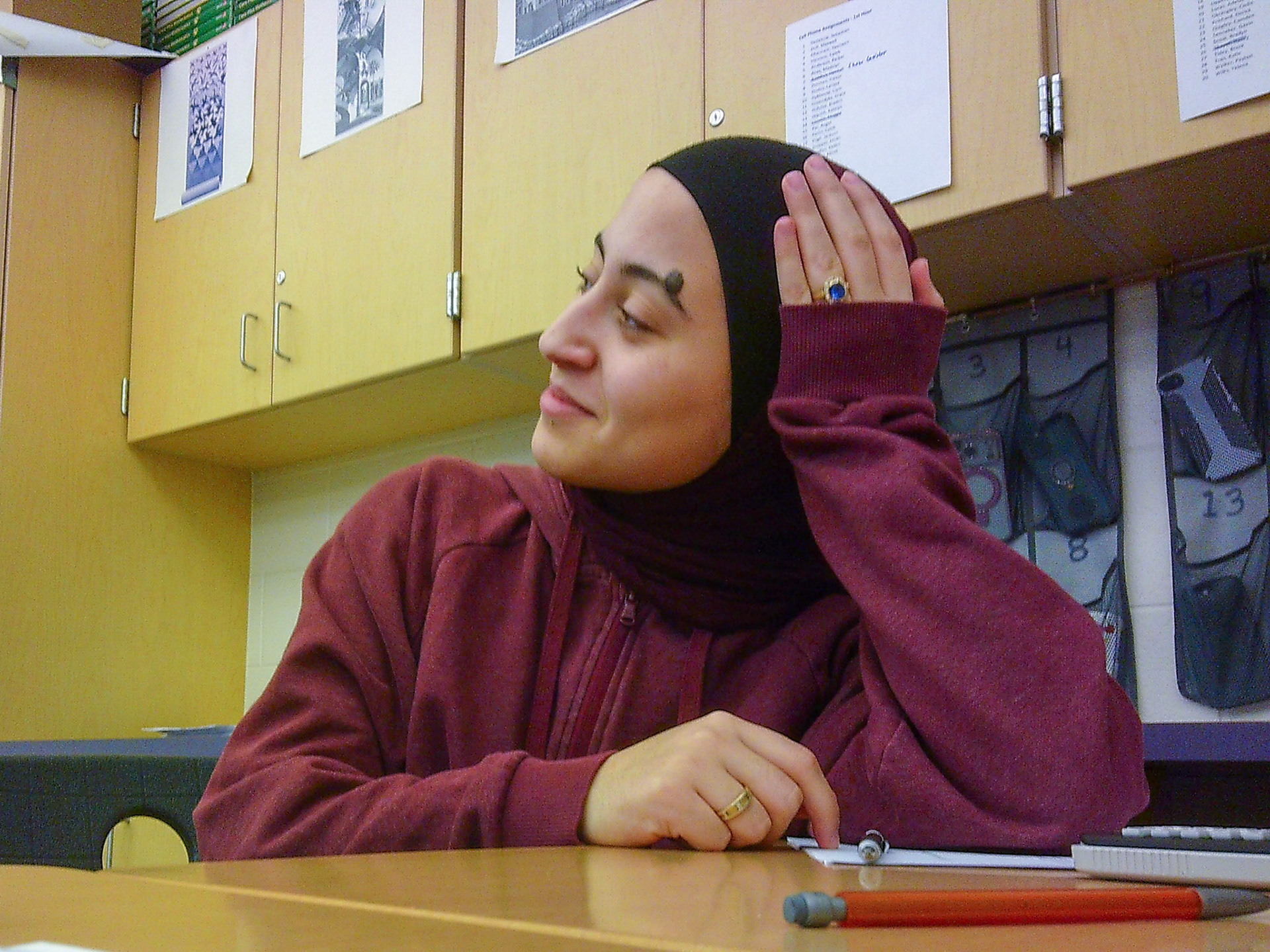 Senior Yasmeen Ghannam looks up at the whiteboard as Mr. Paarlberg explains the last AP Stats probability example. (Photo by Avarey Lippert)g