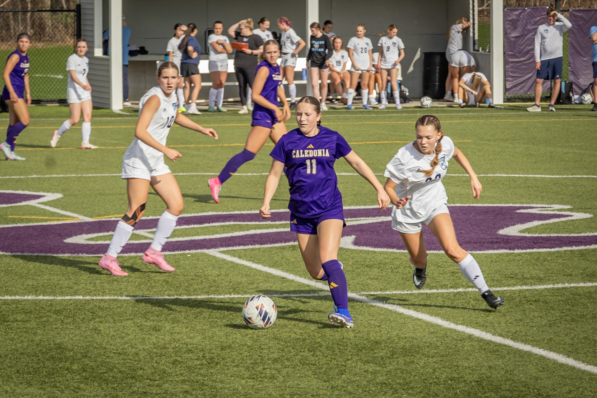Keira Doerr moves around a defender with the ball before passing to a teammate. (Photo by Lucas Swartz)