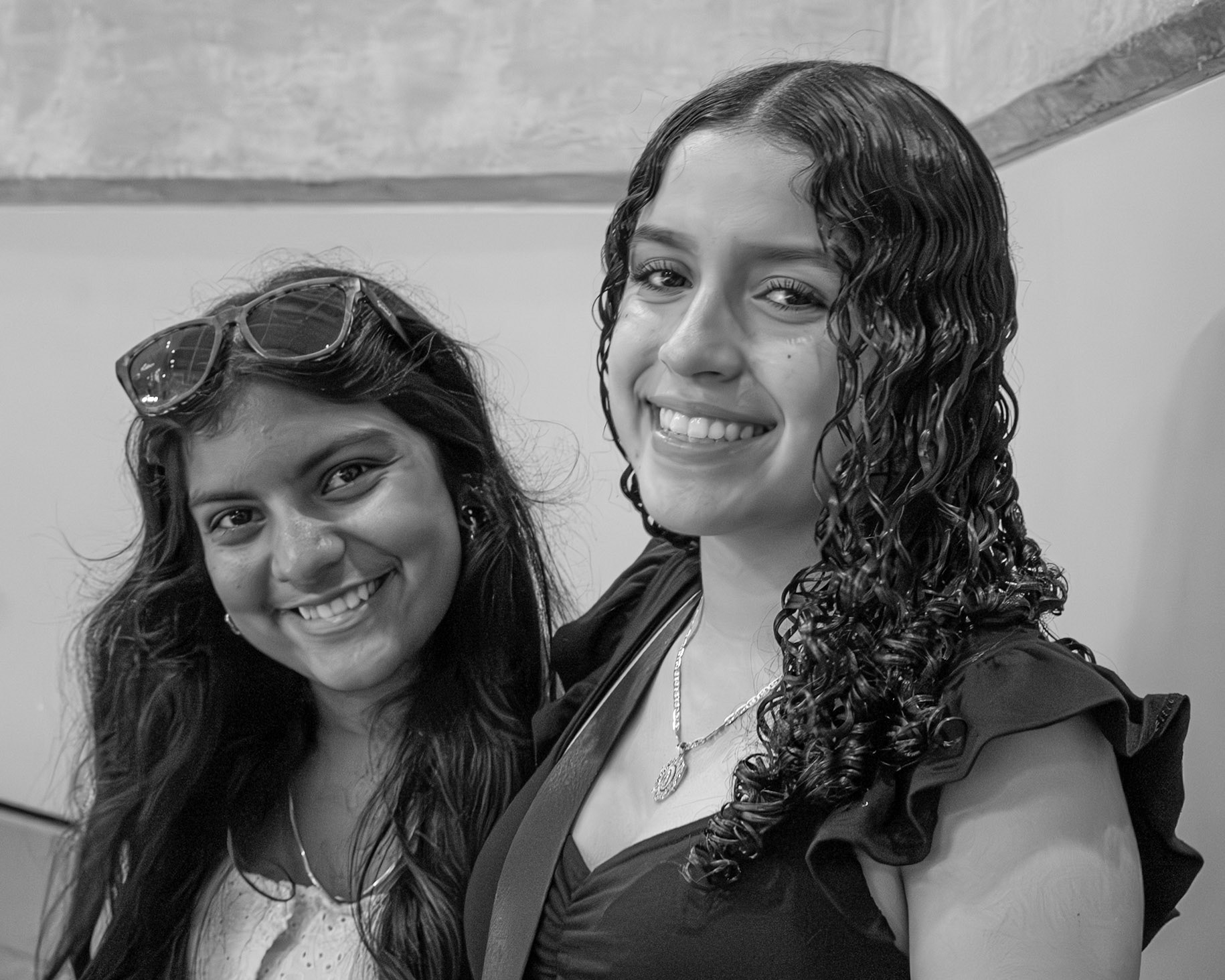 Sophomores Jocelyn Sanchez and Shrimathi Kumar sit in the crowd at the senior assembly watching the seniors walk the stage. (Photo by Elsha Bytwork)