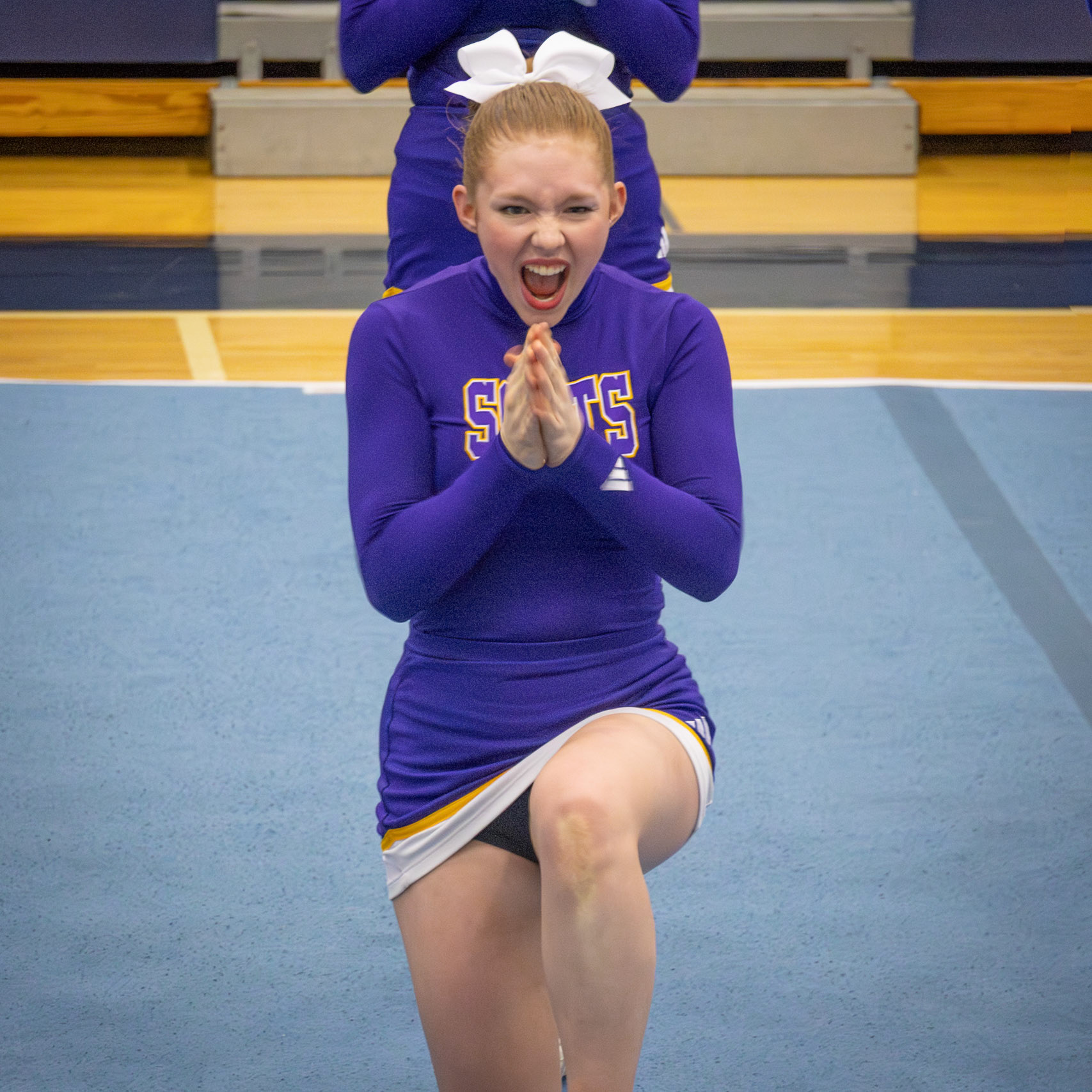 Abi Putnam lights up the mat with her bright facials, bringing energy and personality to the first round. (Photo by Lilli Jackson)
