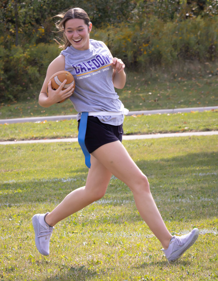 TOUCHDOWN! Senior Avery Helmholdt races in with a huge smile, ready to take on the juniors in the big Powder Puff game. (Photo by Jaren King)