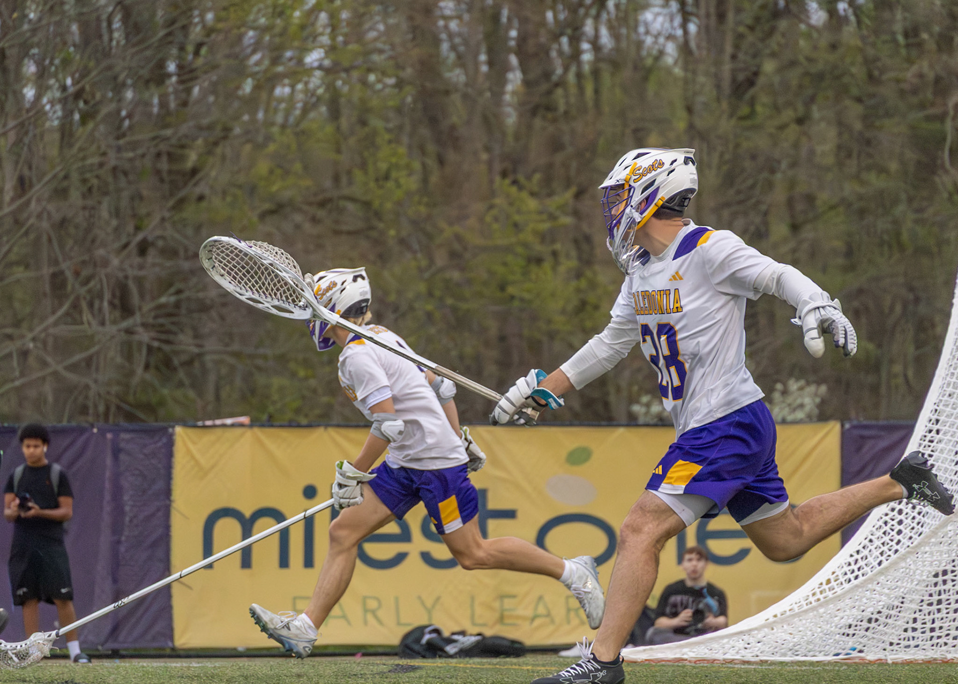 Landen Moore moves behind the net to recover possession of the ball and prevent the opposing team from setting up an attack (Photo by Abby Skibinski).