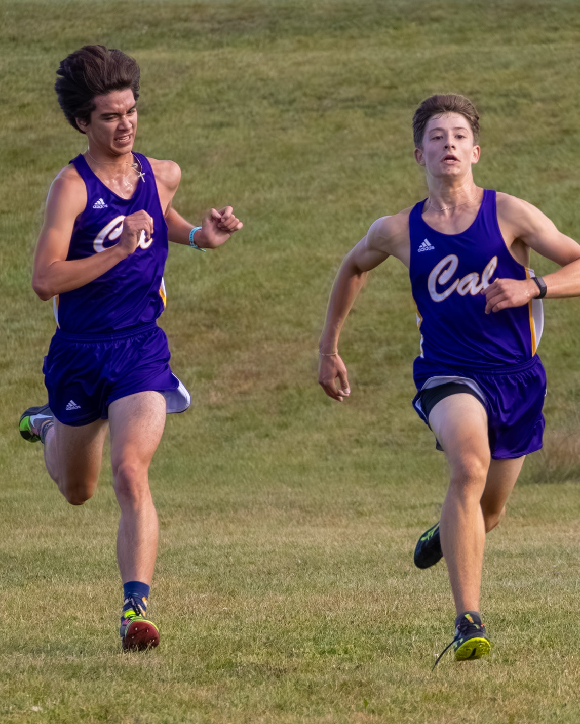 Mason Harrison digs deep in the final stretch, powering past Ian Kimbrell in a dramatic push to the line as both runners fight to finish strong. (Photo by Akaela Daman)