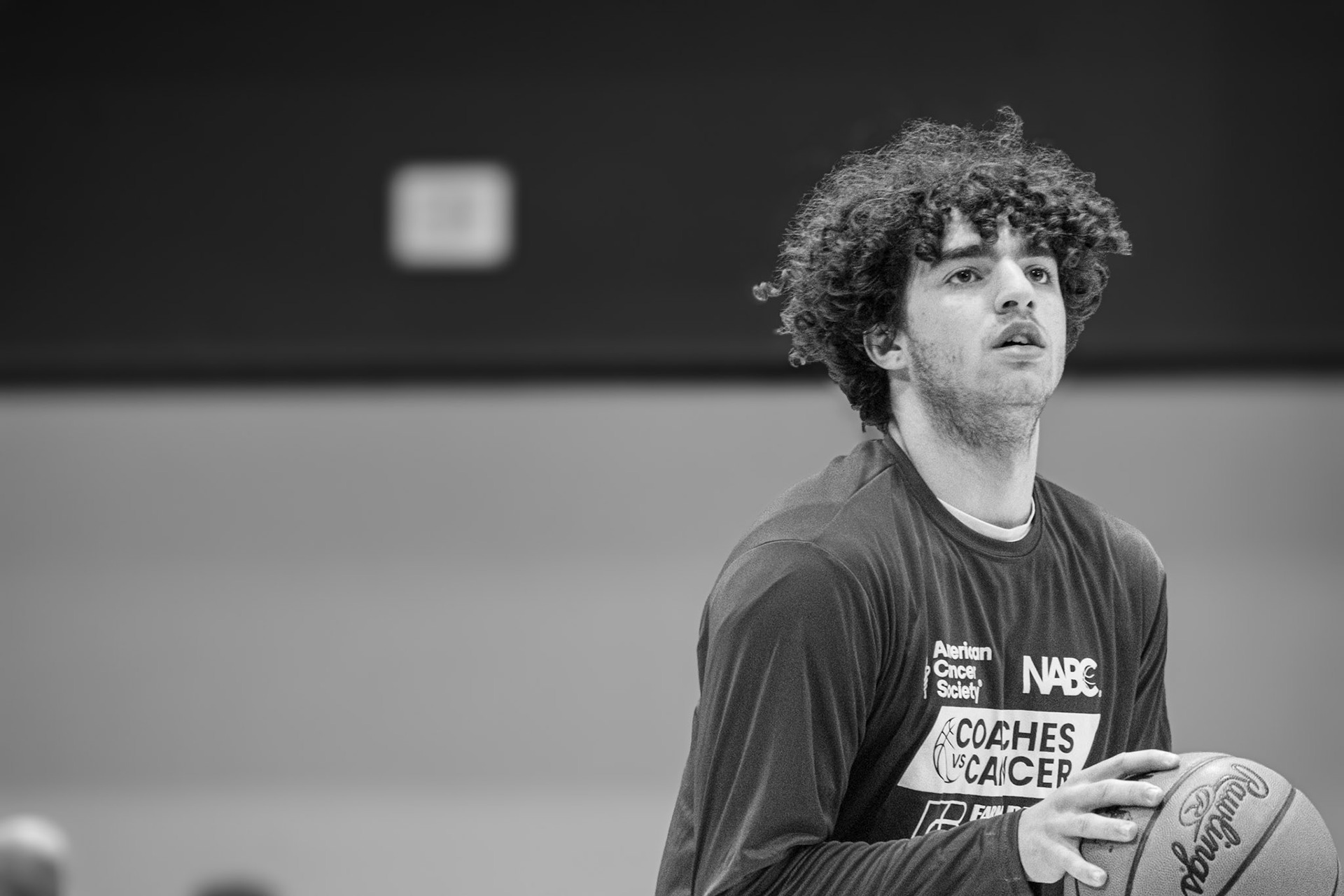 Malachi Hanson warms up before the Senior Night game. (Photo by Aaron Pyper)