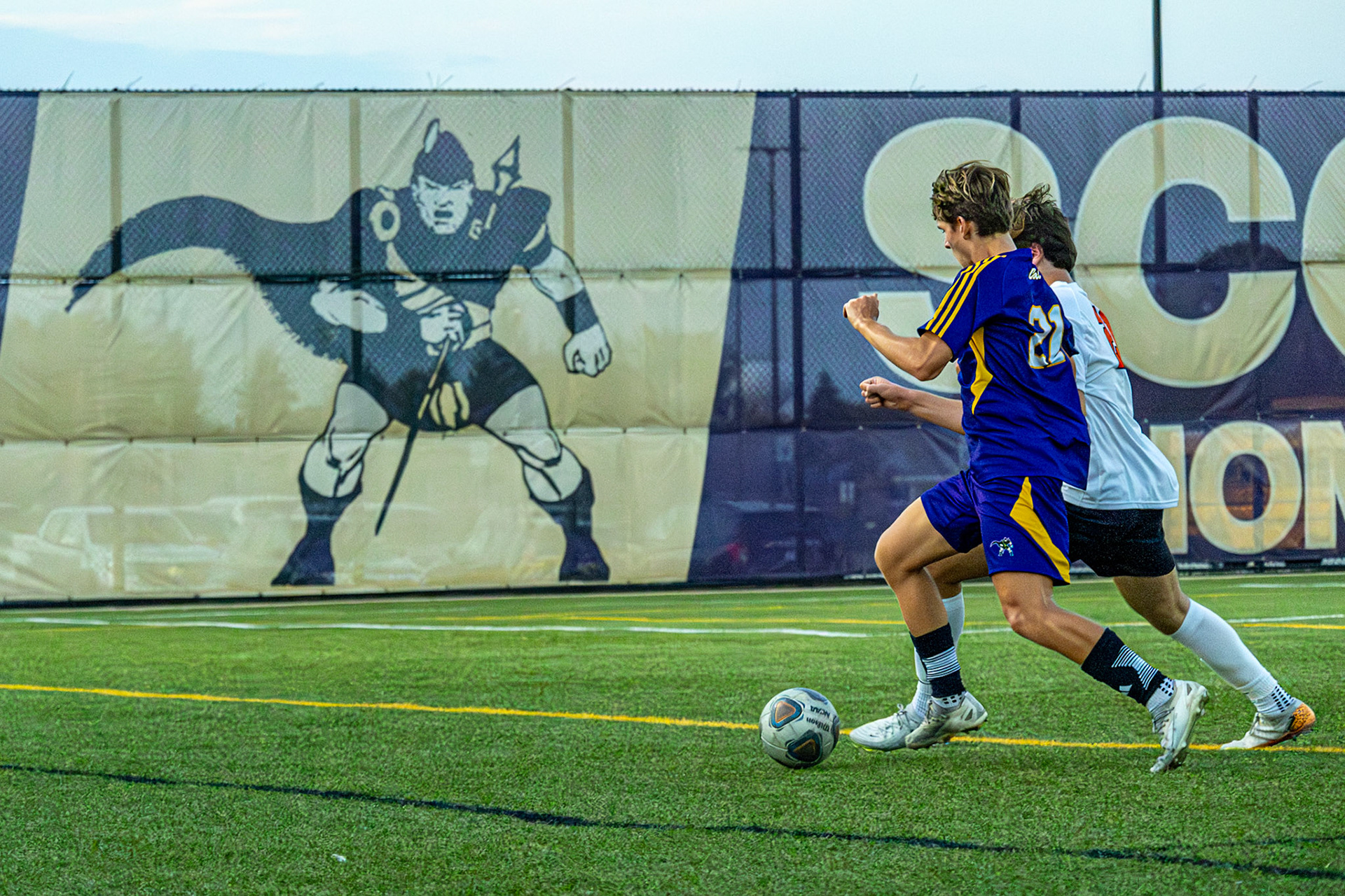 Corbin Ryder races to control the ball against a Byron Center defender.(Photo by Clayton Palmer)