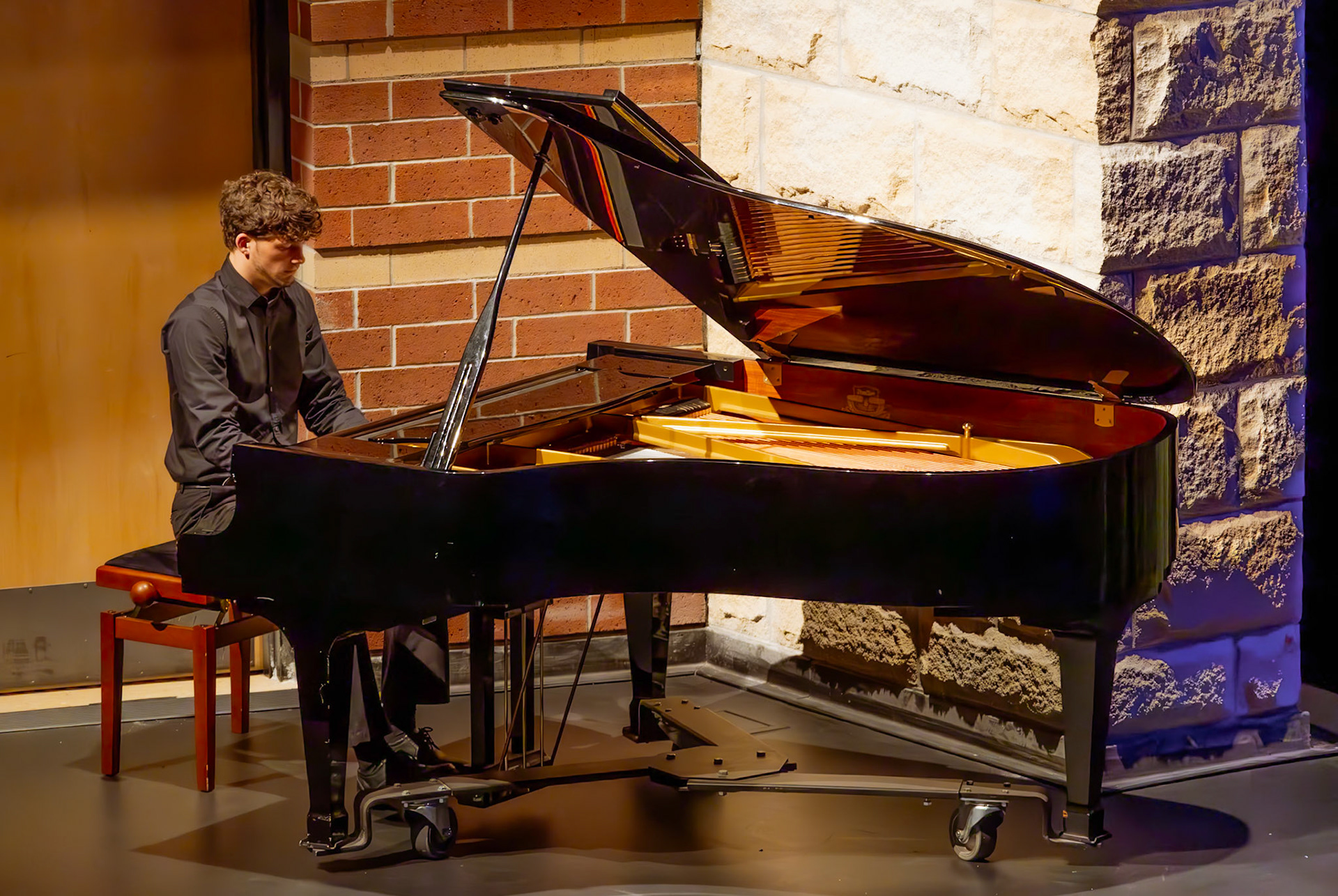 Senior Ben Moss delivers his piano solo, with confidence, emotion, and artistry. (Photo by Molly Larson)