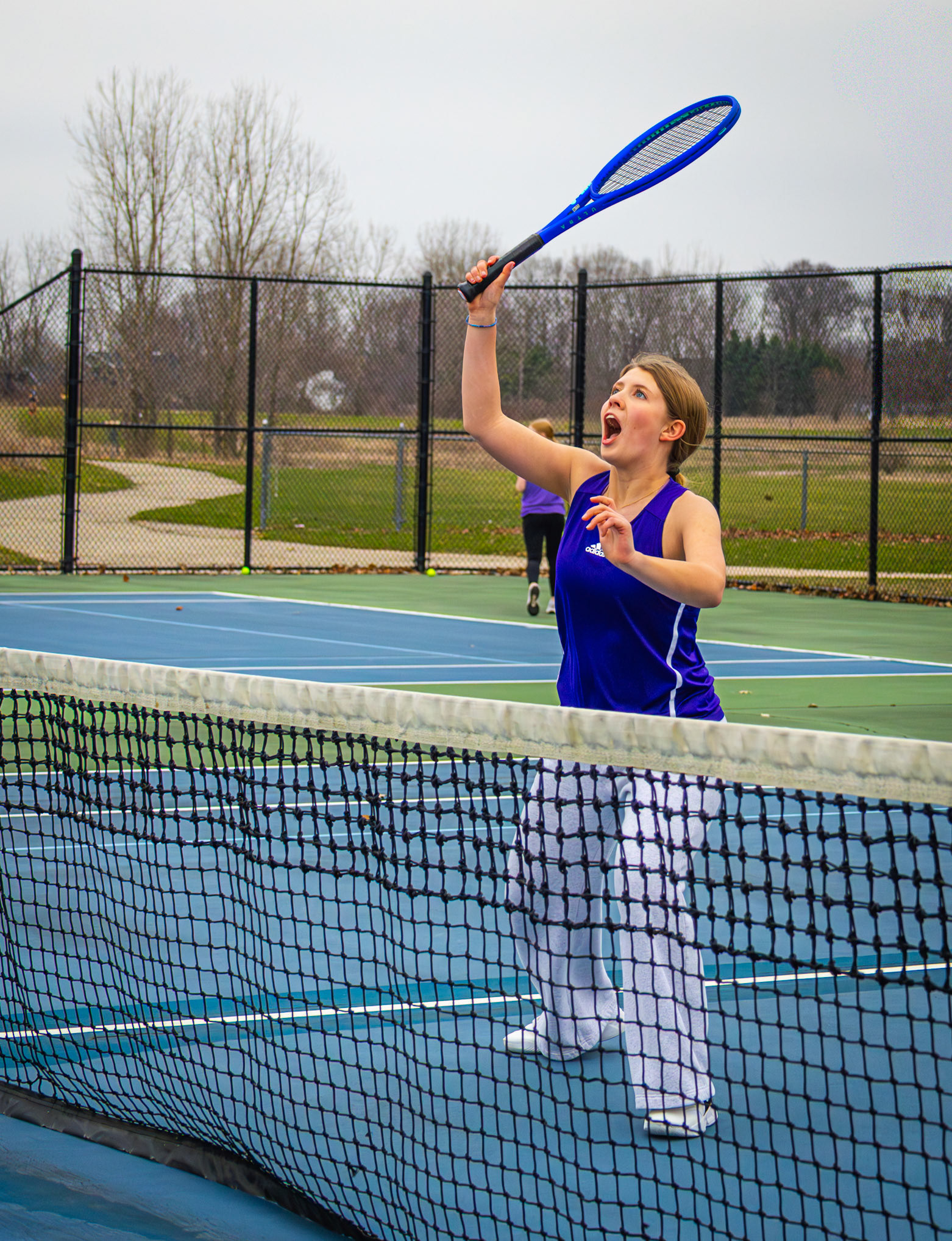 Madison Reynolds takes a playful swing at a tennis ball during practice. (Photo by Stella Wagnerova)