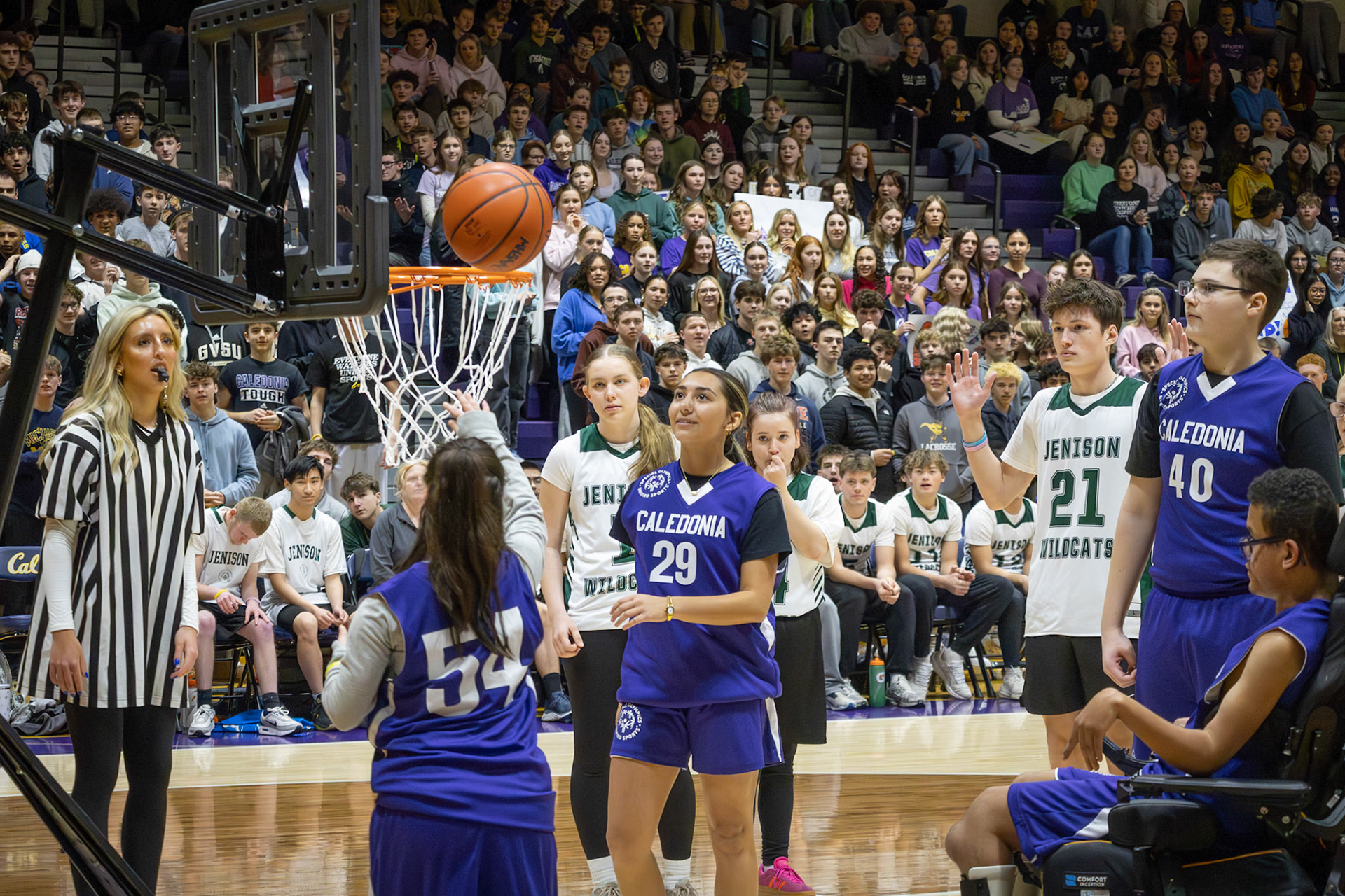 After running to the net with teammate Emma Unger, Alayna Musk goes up for a shot as the crowd watches in anticipation. (Photo by Abby Skibinski)