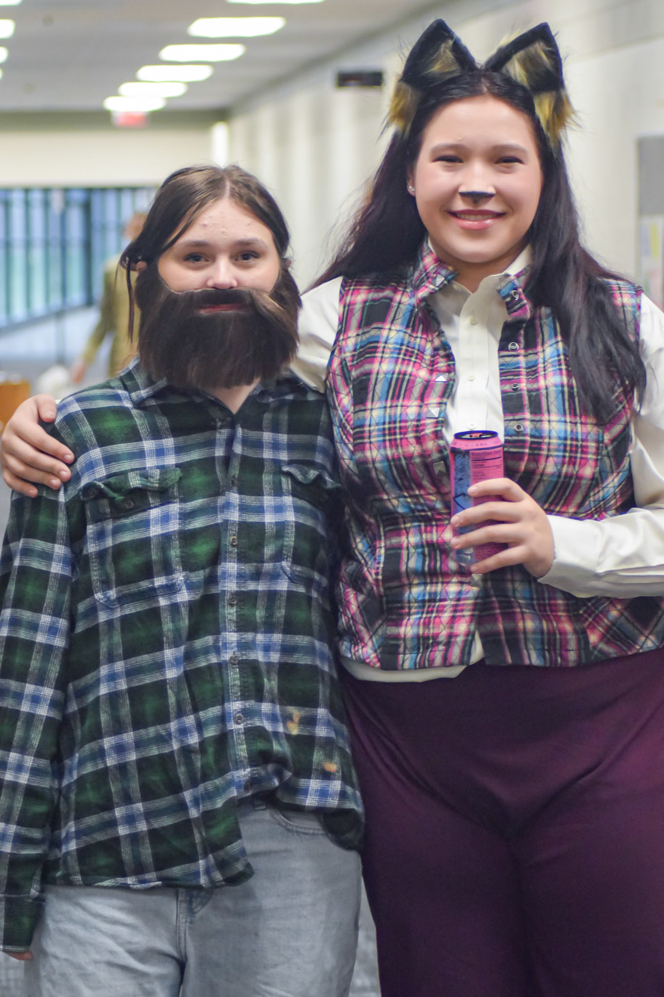 Sophmores Delilah Smith as Dad 1 and Kendall Somerville pas the Big Bad Wolf, pose in the hallway before their costume parade. (Photo by Ollie Fox)