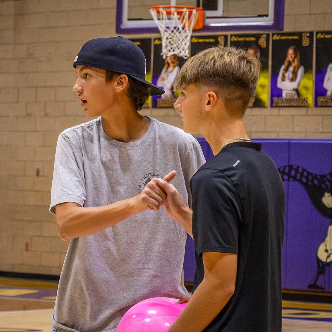 After a game of four-way volleyball, classmates Gaige Allen and Zach Pirkola share a handshake following their win. (Photo by Ella-Grace Wickens)