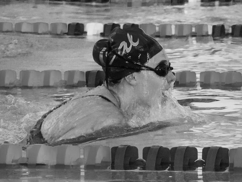 RACING AHEAD Reagan Cobbs powers through the water with a strong breaststroke during the Swim and Dive meet against East Kentwood. (Photo by Elise Clarin)