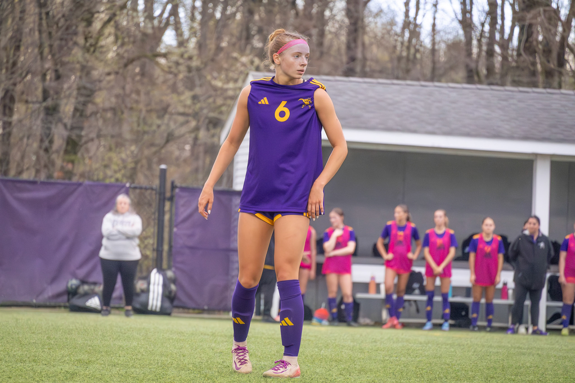 Kelsey Roszkowski stands alone mid game, eyes locked on the ball as the play unfolds .(Photo by Ava LaBine)