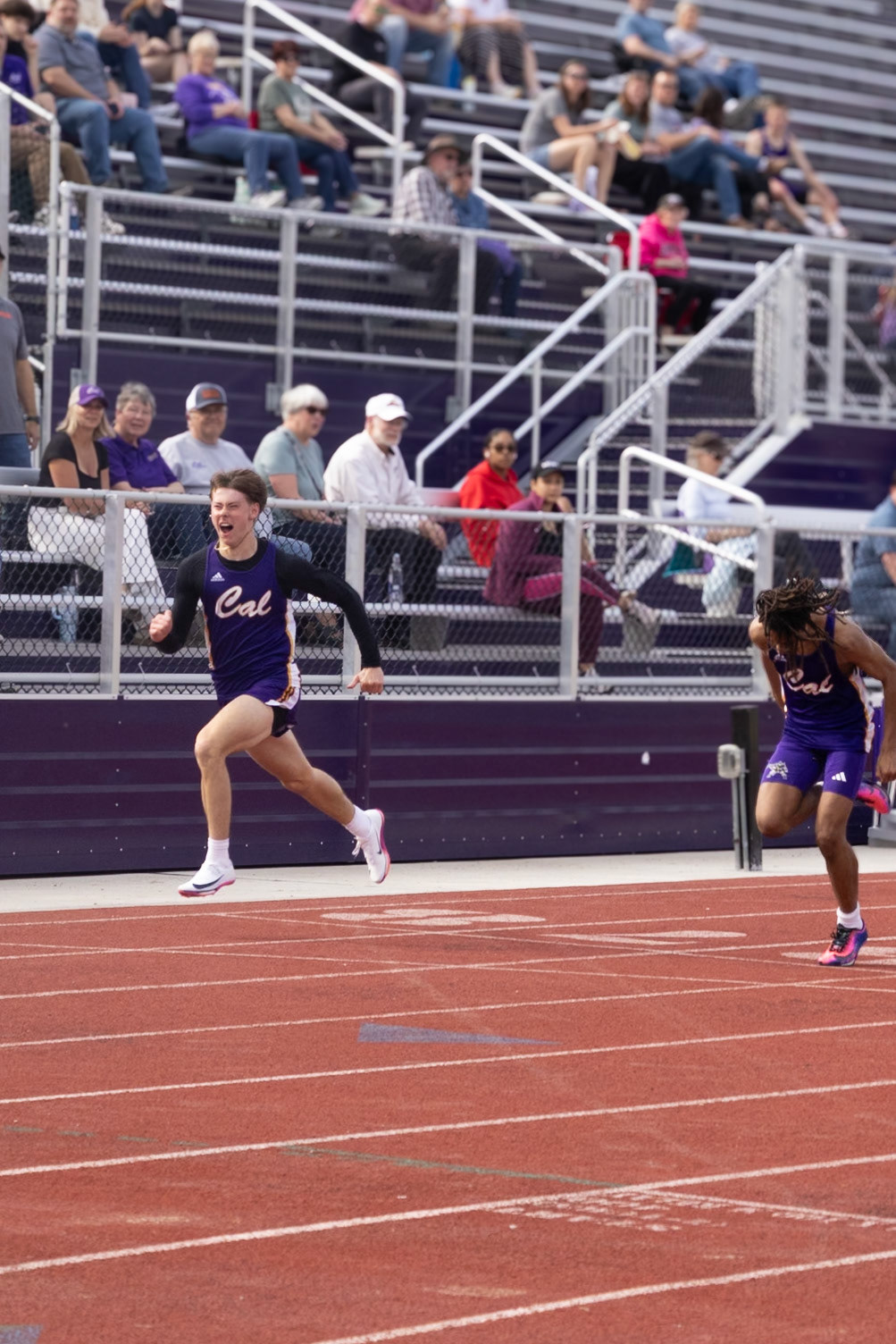 Miles finsihes his 100m dash with a confident victory and a new PR. (Photo by Adi Malvankar)