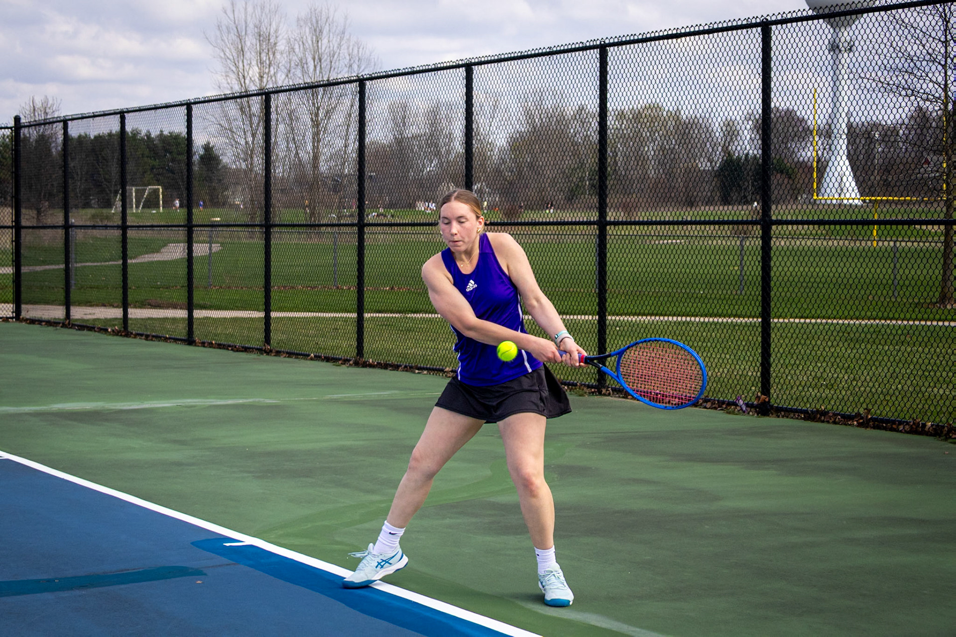 Molly Liggett moves into position, swinging through the ball with focus and control as she sends it back across the court. (Photo by Hailey Thayer)