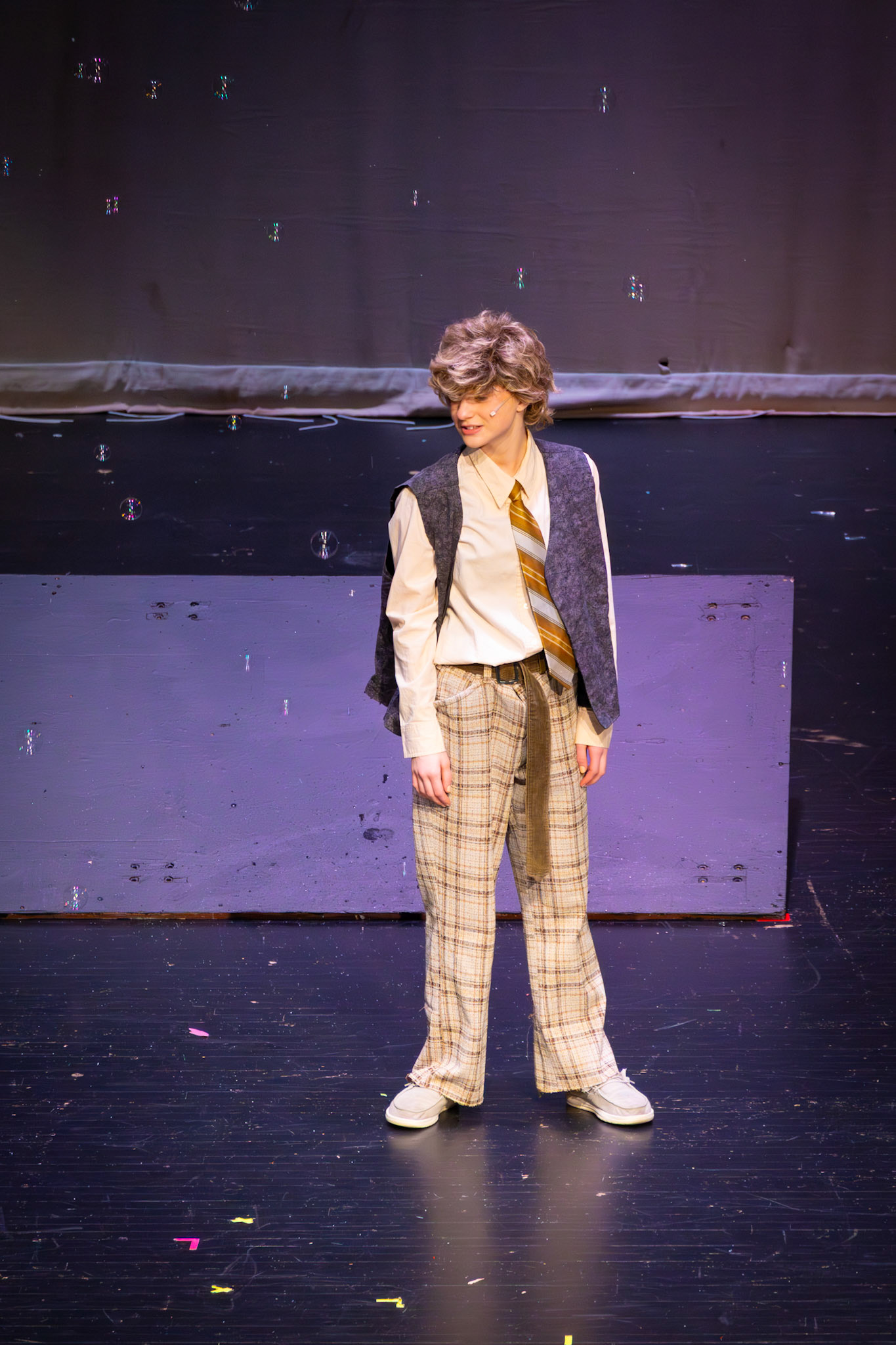 Caught in the magic of the moment, Charlie, played by freshman Emma Kellogg, sings as bubbles drift down around her, turning the stage into a dreamlike scene. (Photo by Mackenzie Popma)