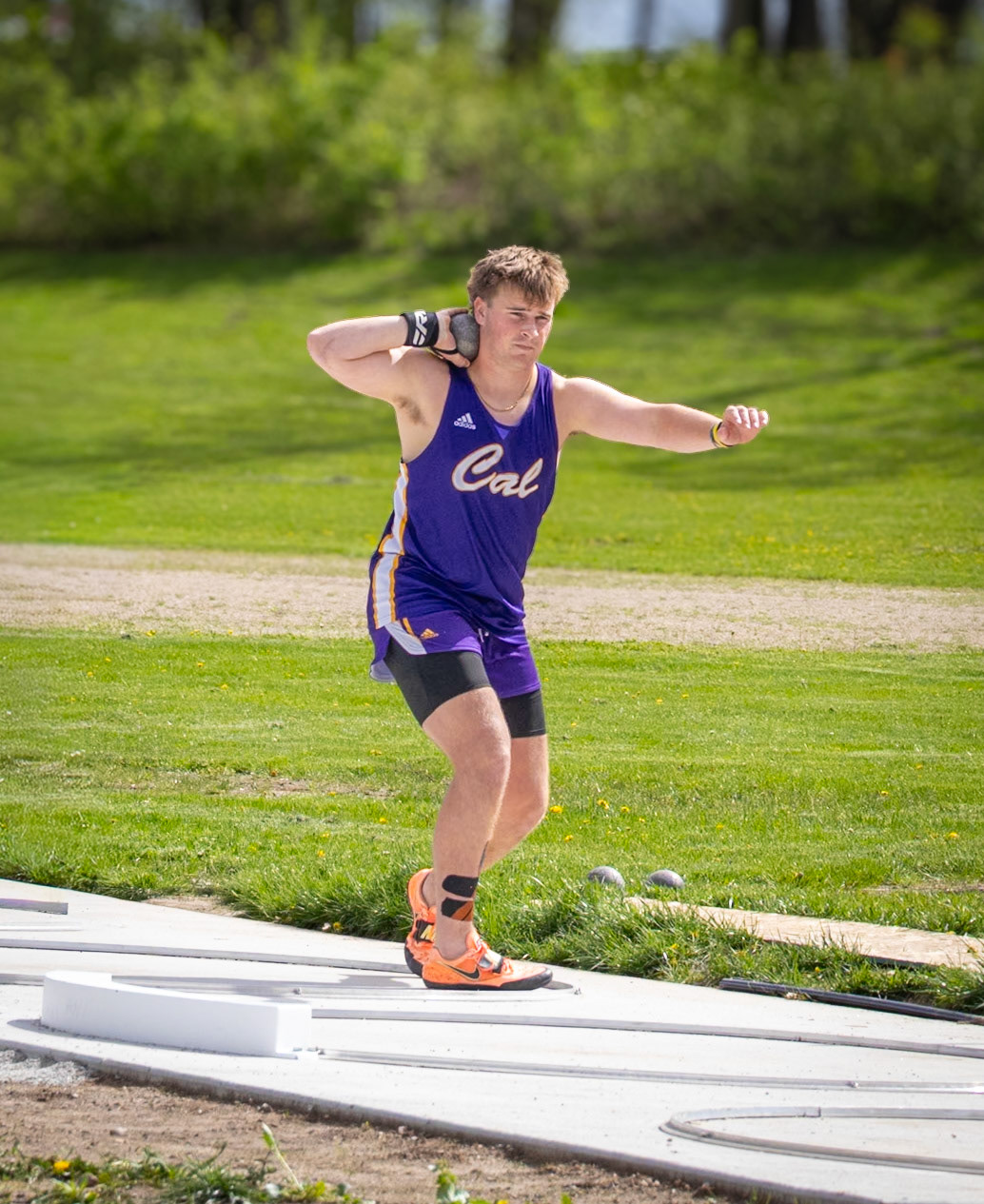 Elliot narrows his focus before the throw, locking in on his form as he prepares to explode into the release.(Photo by Aibree Akers)