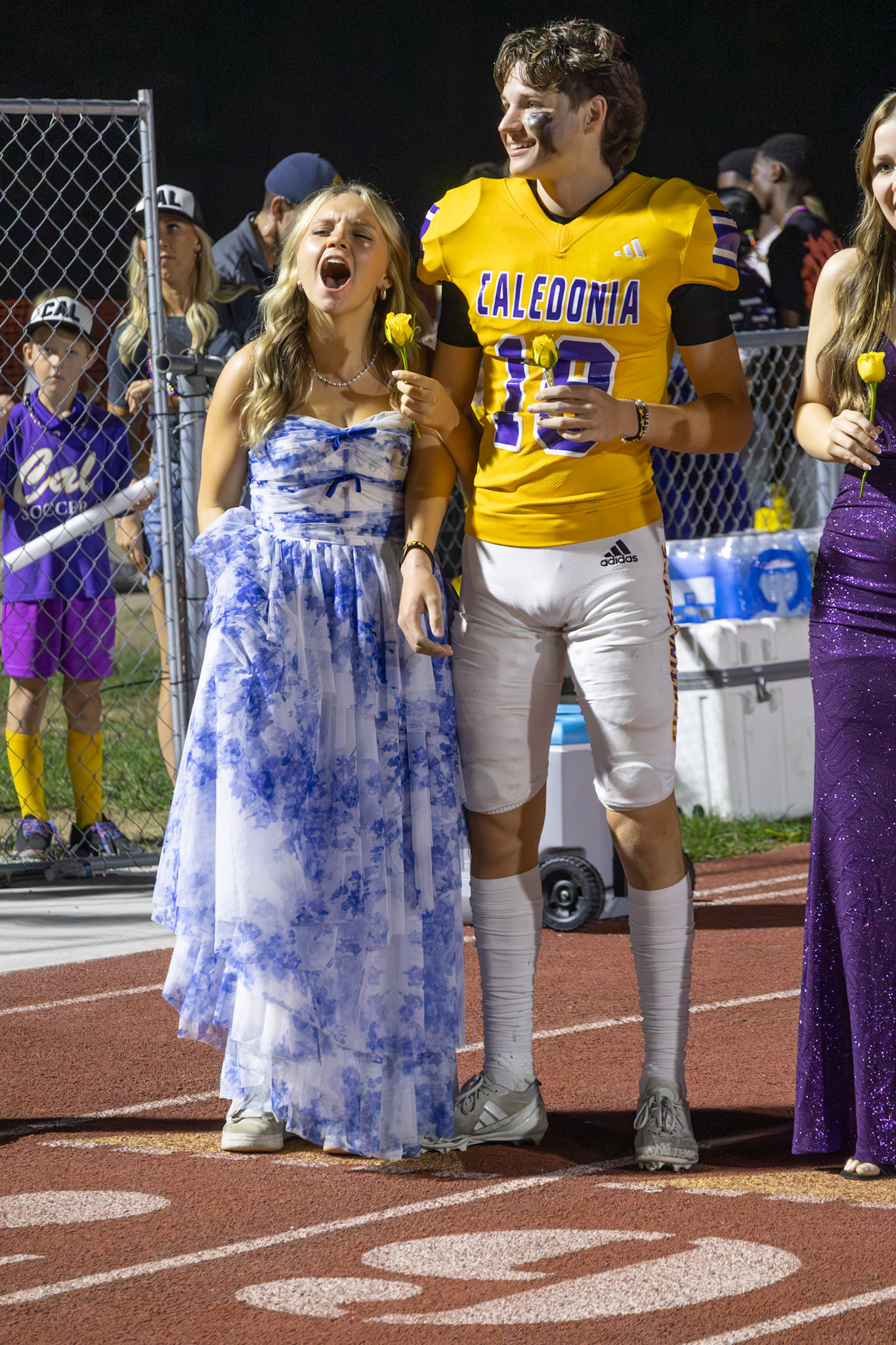 Avery Middlemiss and Parker Lipsman cheer on their freinds before walking the track - and being  crowned homecoming King and Queen. (Photo by Taya Penoes)