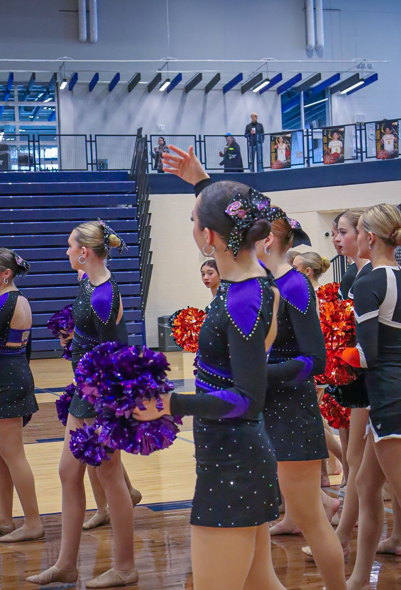 Varsity Dance Team Captain Avarey Lippert waves her team over after the national anthem to get their picture taken. (Photo by Jaylah Naves)