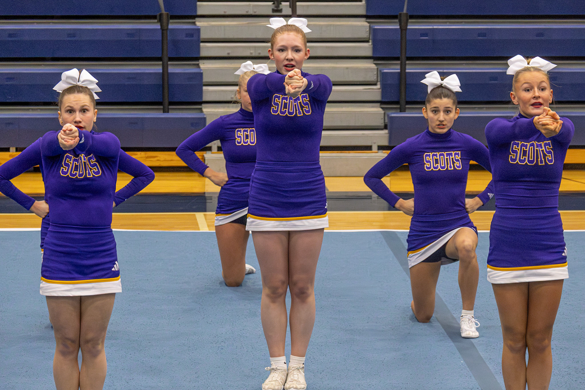 Front and center, Abi Putnam, Mariah Peterson, and Alyssa Jernigan made the first round unforgettable with their jumps and energy. (Photo by Lilli Jackson)