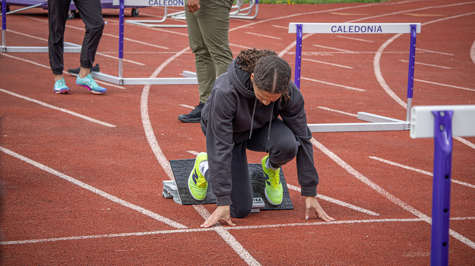 Before a race, Melanie Genao Grullon practices her hurdles. (Photo by Emma Garza)