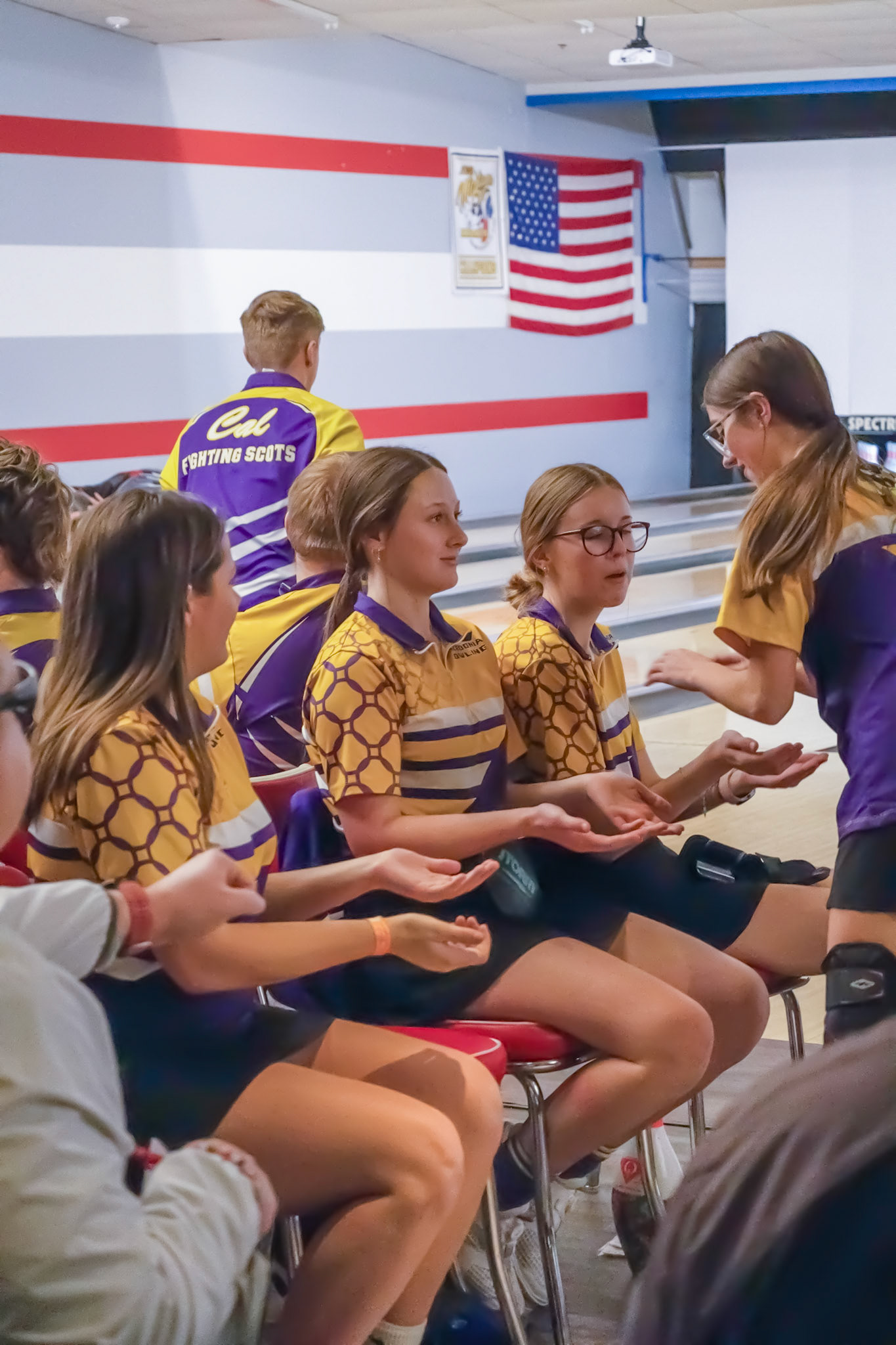 keni high fiving the gilrs on the bowling team after a strike (Photo by Kacy Rosted)