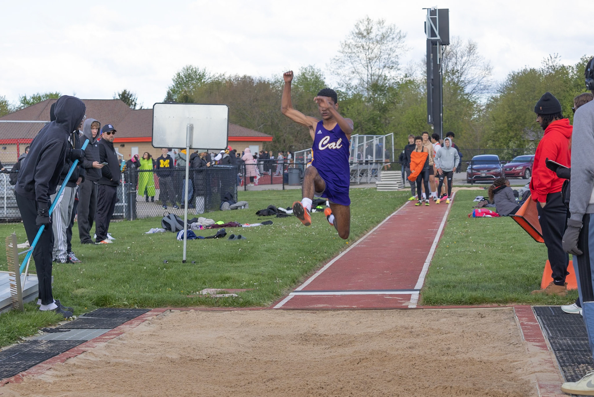 Junior Joell Gordon-Reyes approaches his long jump landing with focus and determination, pushing through the moment of doubt as he aims to stick his best jump yet. “Am I going to make this? Will I scratch? I can do this—I can actually jump my highest.” (Photo by Mya VanderZwaag)