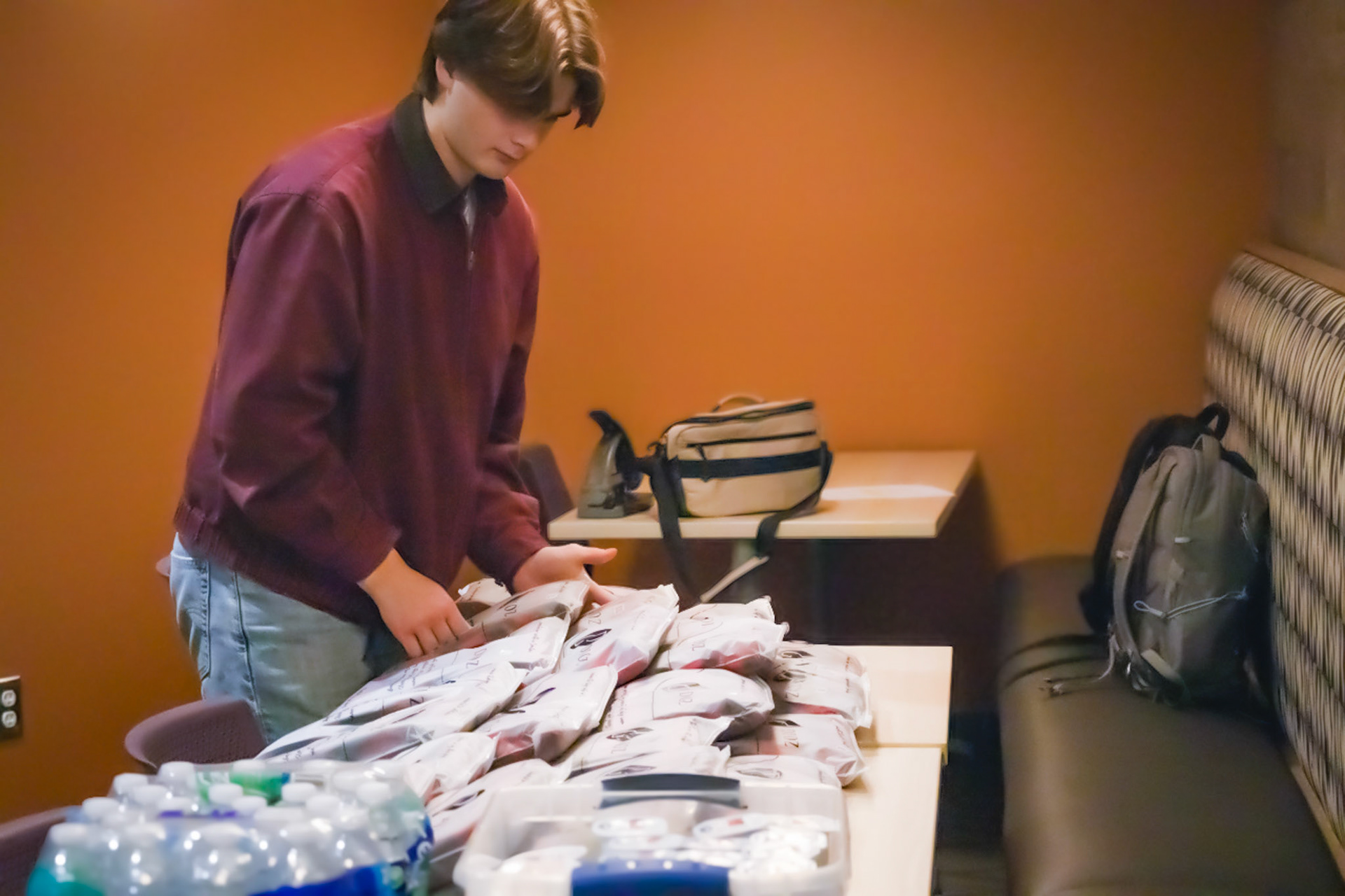 Senior Cole Nyman organizing the pajama pants donnors get after they donate there blood. (Photo by Tana Coates)