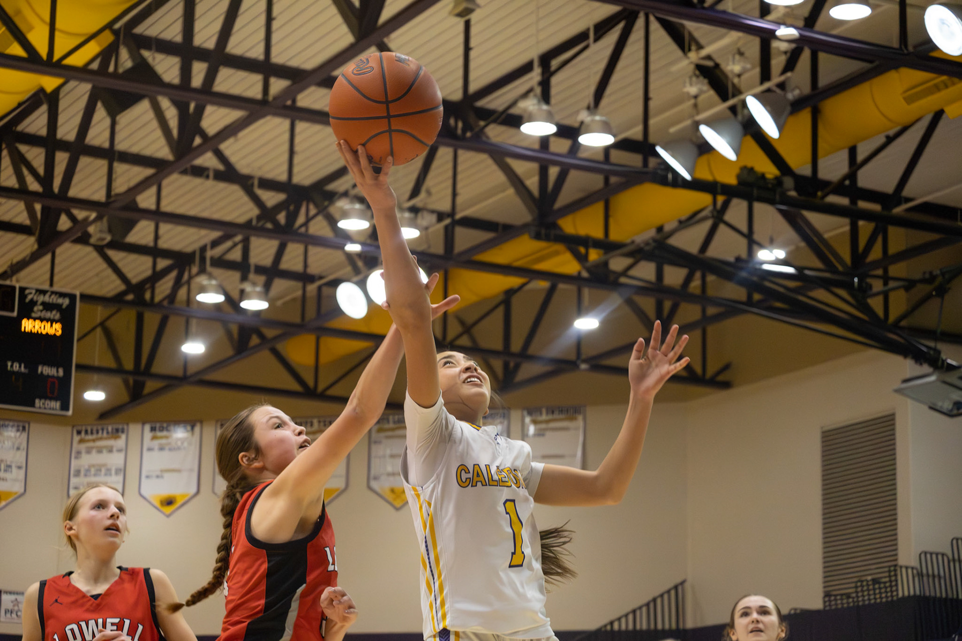 Braylee Tep attacks the basket during a contested play against Lowell. (Photo By Landry Mueller)
