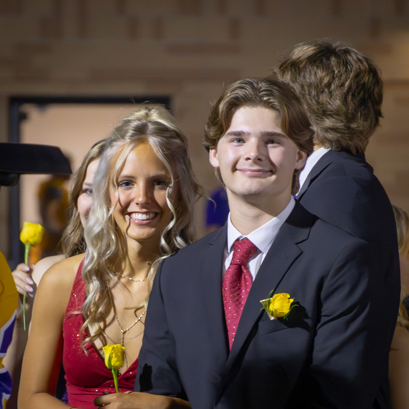 Tana and Cole share a smile while waiting to walk down the track and find out who will be crowned Homecoming Court winners. (Photo by Taya Penoes)