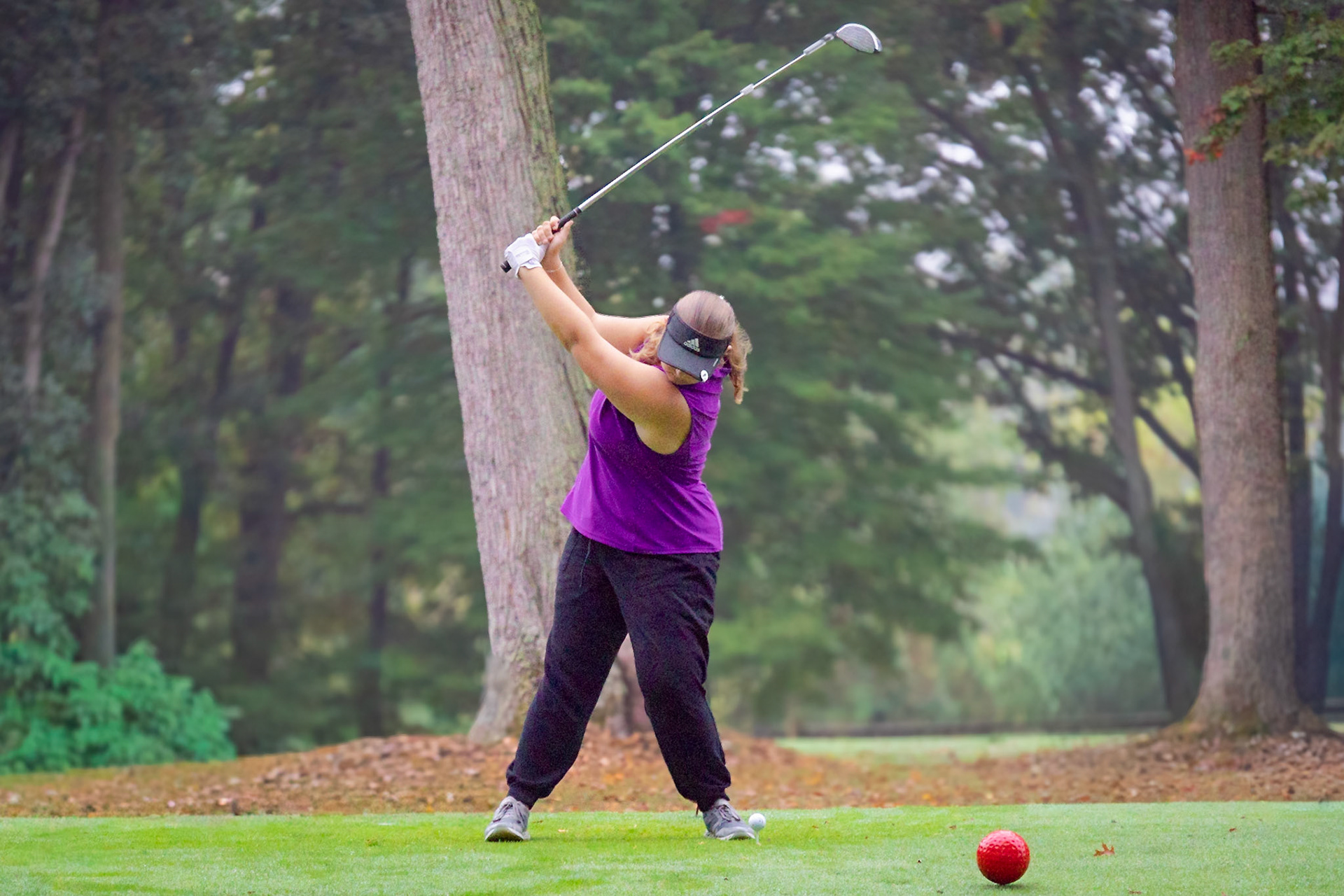 SMOOTH SWING  Senior Rosalyn Langworthy lines up to the ball for a nice looking practice swing. (Photo by Ryder Born)