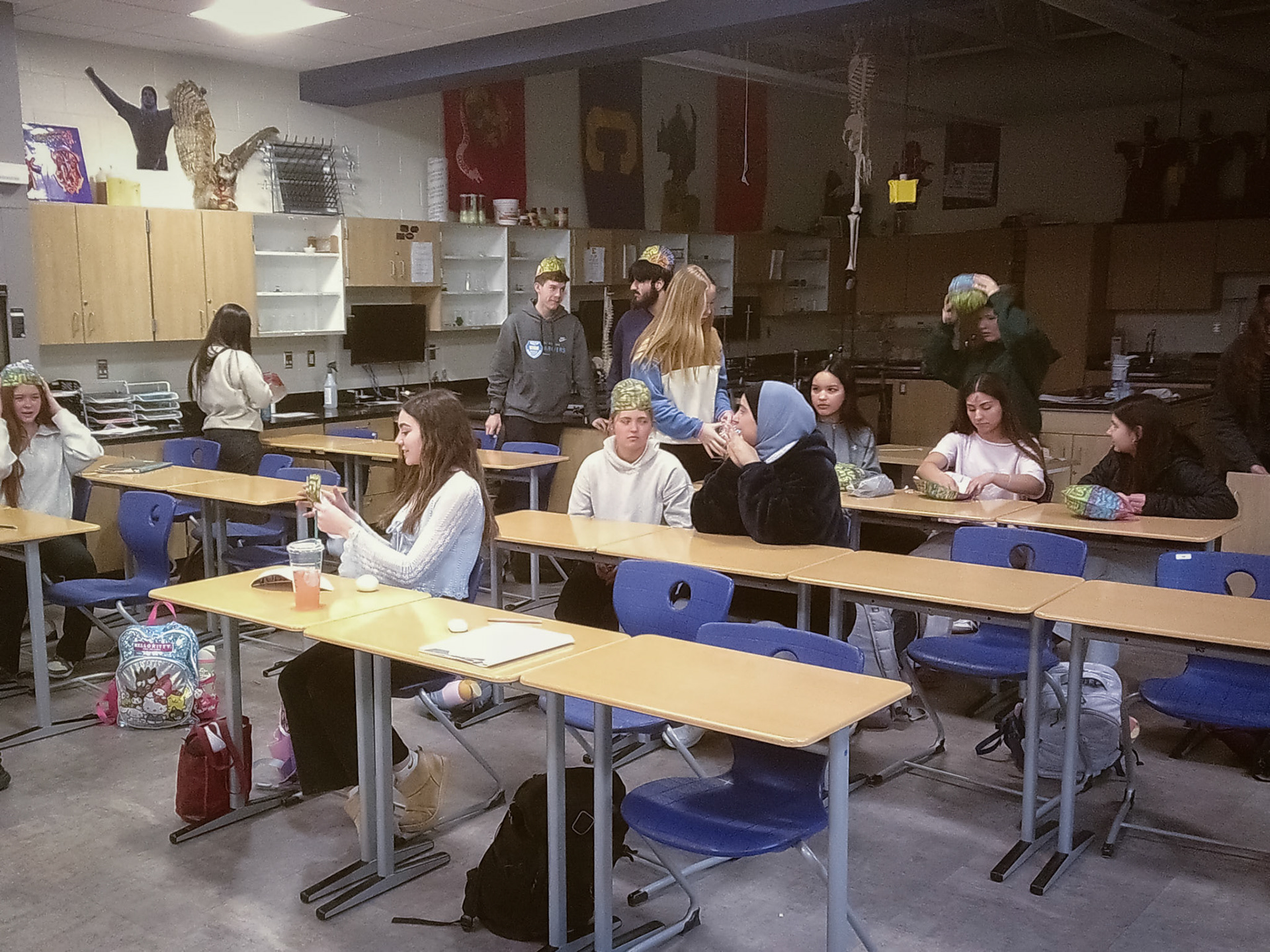 BRAINY BUNCH Mr DeHorn's human anatomy class tries on their color-coded brain hats to study the regions. (Photo by Avarey Lippert)