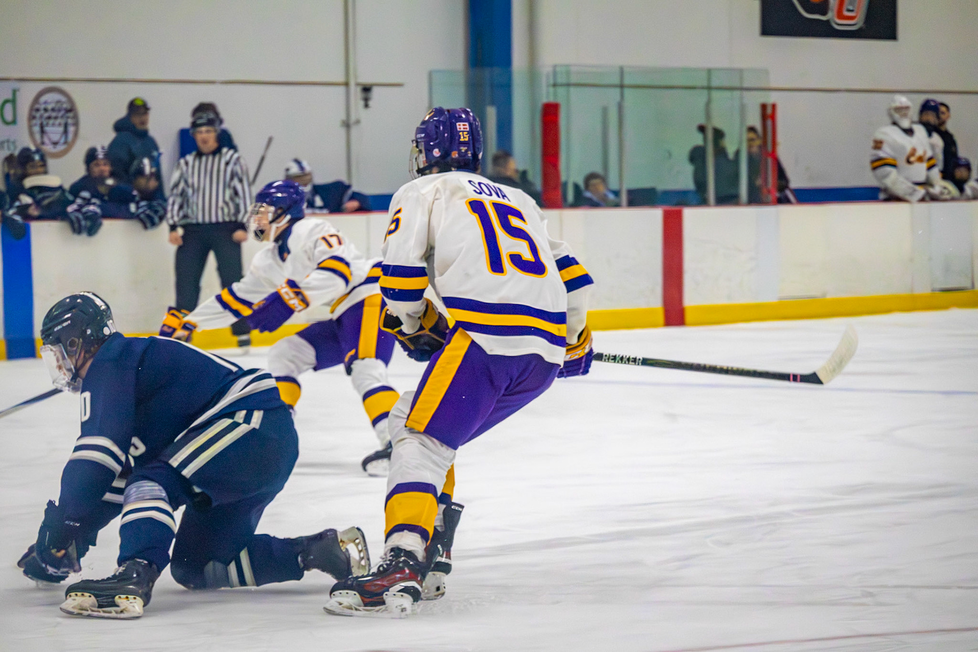 As a Marysville player falls to one knee, Ethan Sova looks on while William Maelum-Micheelsen scrambles for the puck.(Photo by Avarey Lippert)