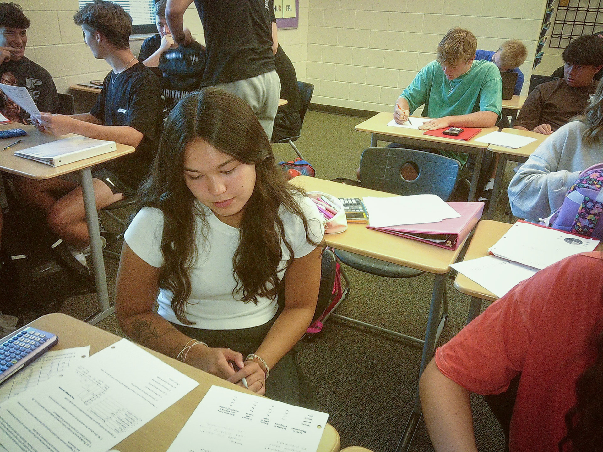 Ellie Tennant Focused and determined, she’s deep in thought as she tackles her stats homework, carefully analyzing the numbers and trying to solve the problem step by step. (Photo by Tana Coates)
