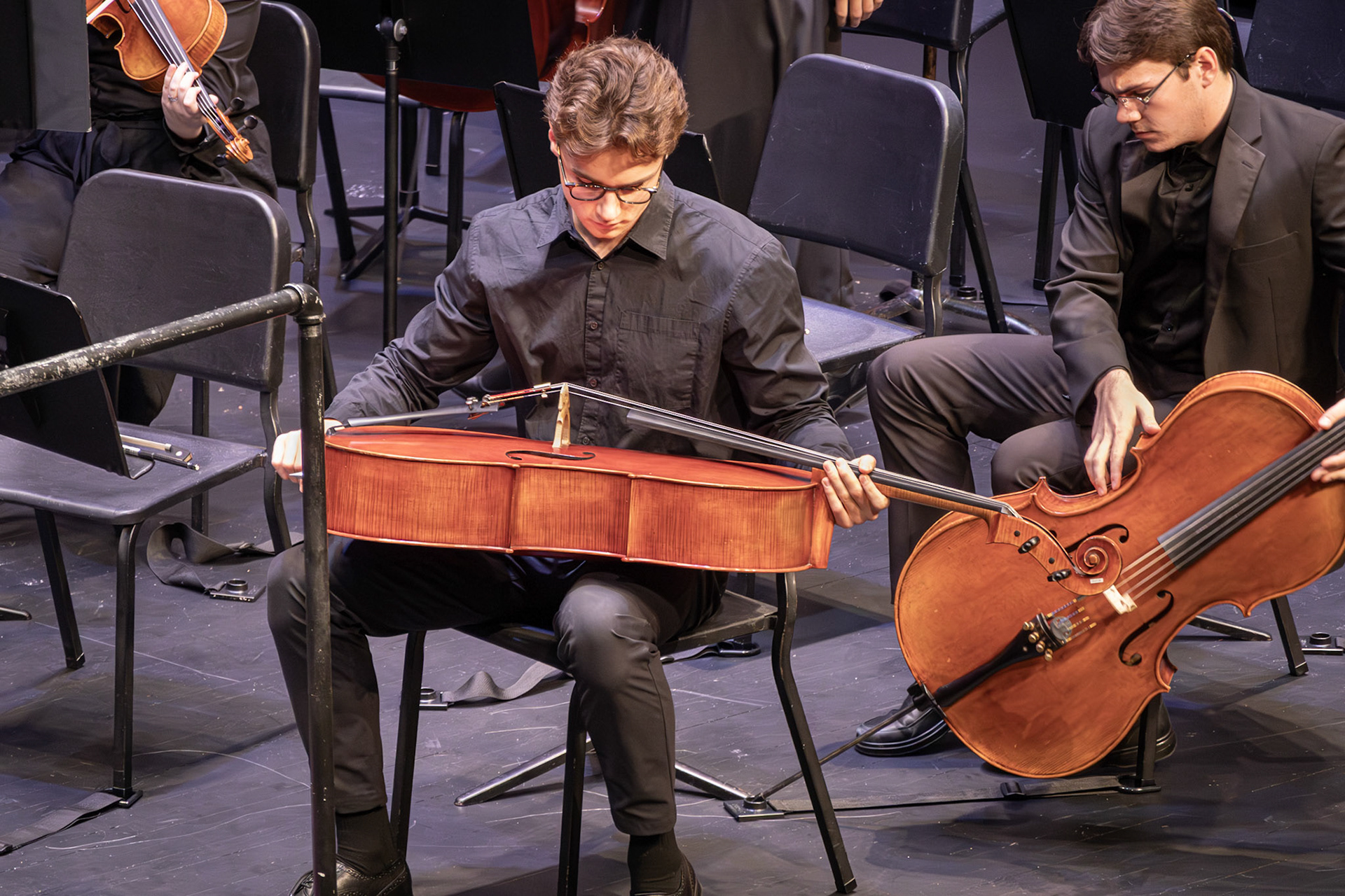 FOCUSED Senior Ethan Snapper takes a quiet moment with his cello before the music begins.(Photo by Ava LaBine)